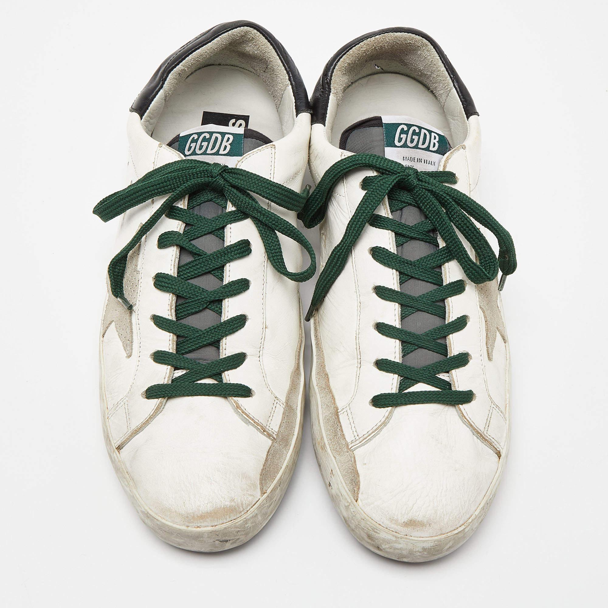 The white sneakers offer a wave of comfort. The Golden Goose sneakers have been crafted with suede as well as leather and they are easy to slip on. The trendy shoes feature star details, lace-ups and the comfortable insoles make them ideal to wear