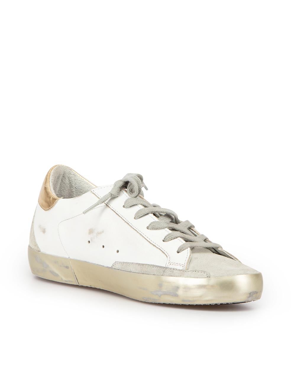 CONDITION is Never Worn. No visible wear to trainers is evident on this used Golden Goose designer resale item. These shoes come with original dust bag.



Details


White and gold

Leather

Low top trainers

Lace up closure

Distressed