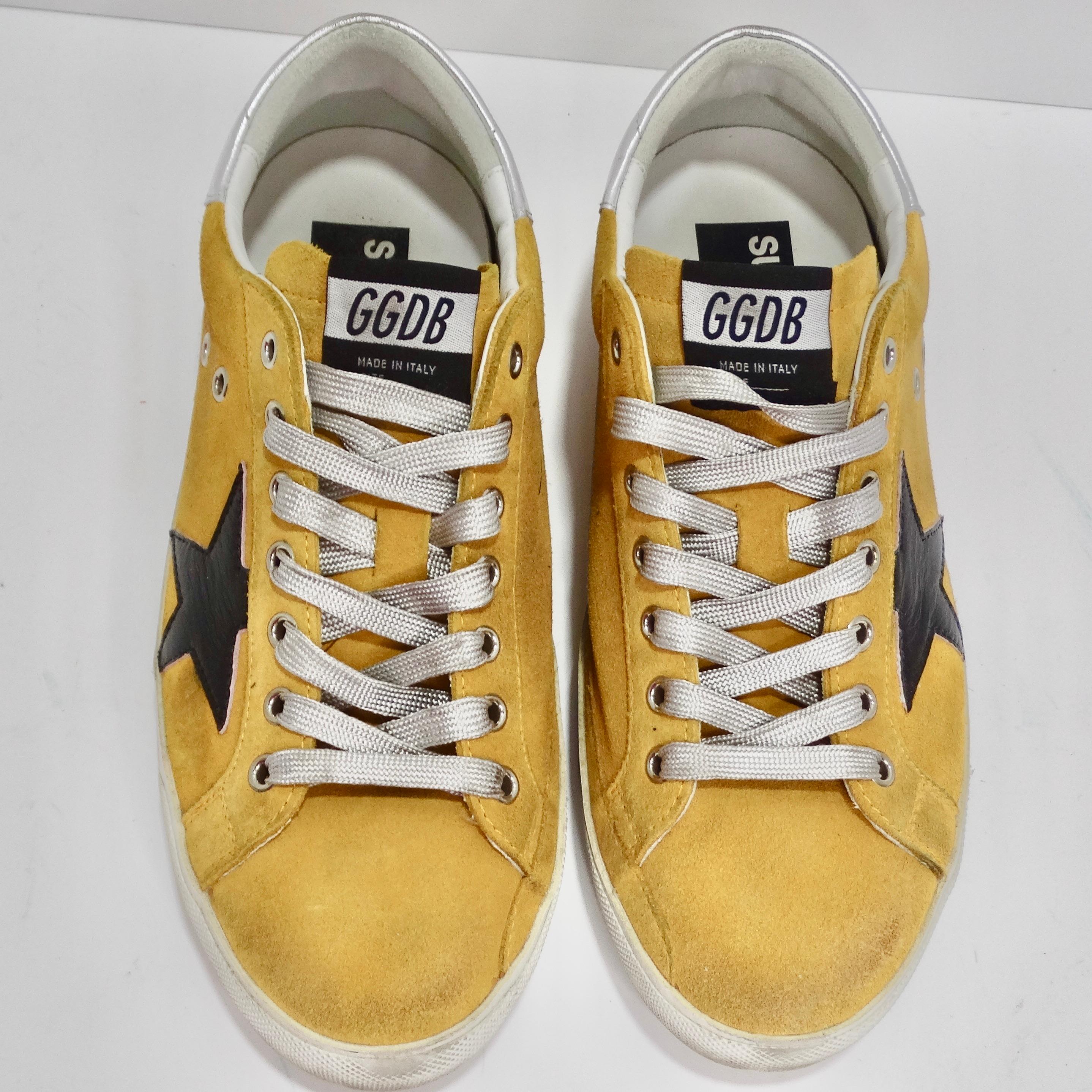 Step into unique style with these Golden Goose Yellow Leather Superstar Sneakers! Crafted with premium yellow suede and adorned with bold black leather stars on the sides, these sneakers are a fashion statement on their own. Their signature