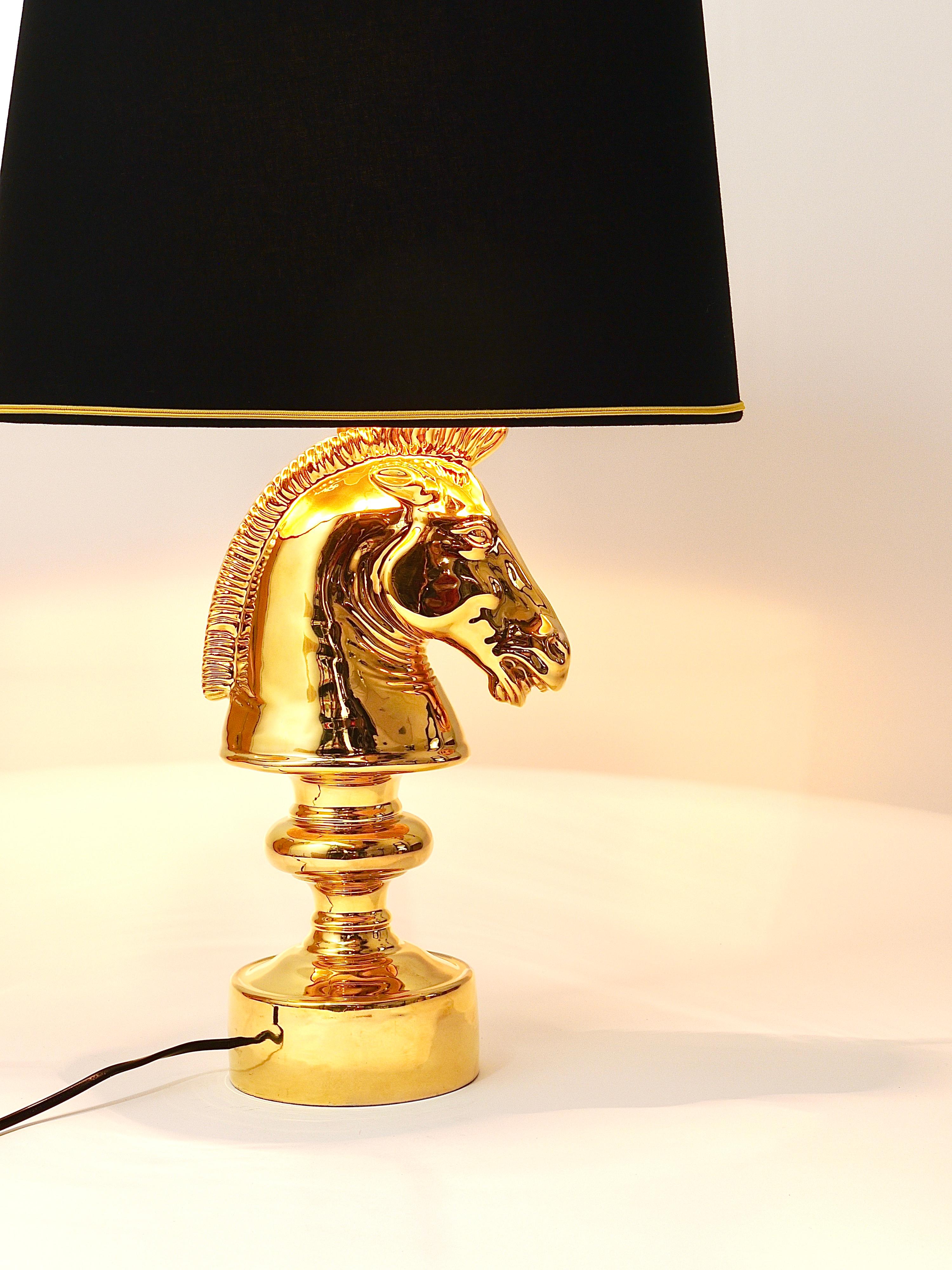 A gold-plated sculptural Hollywood Regency style table lamp from the 1970s in the shape of a horse chess piece. Made of ceramic by Behrend Firenze, Italy. Signed on its underneath. In good condition, no damages, marginal signs of age in the