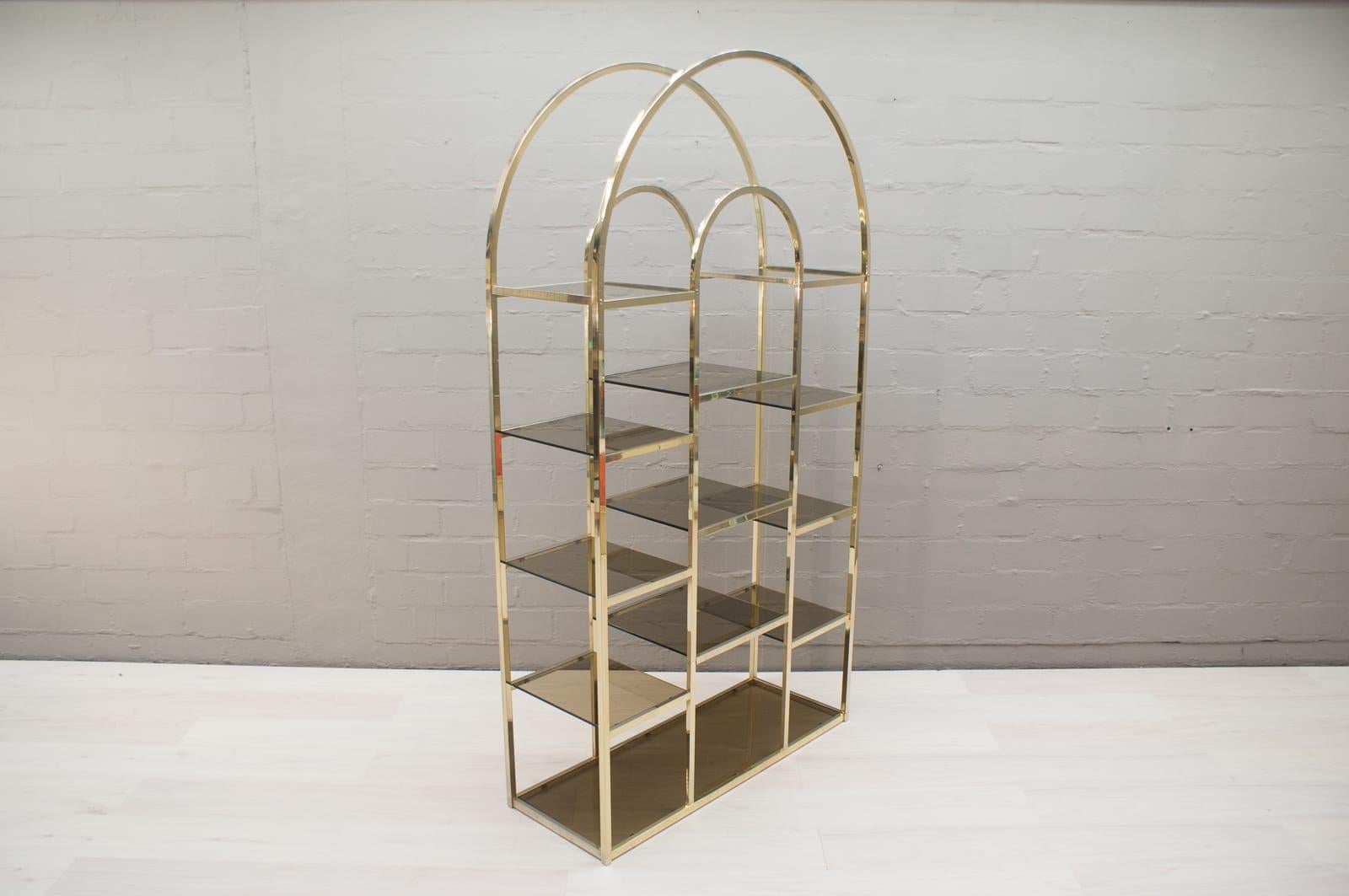 This shelving unit features a golden brass frame and black smoked glass shelves.

Was bought by the previous owner in France in the 1970s.


 