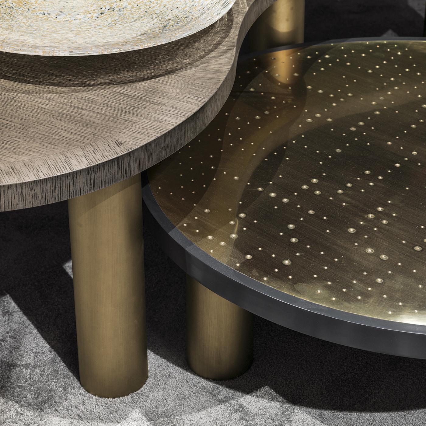 Low to the ground, the Golden Jade Coffee Table will nevertheless receive more than a fair share of attention thanks to its glistening finish. Featuring a wooden top, the table is accented with hand-painted brass detailing. Joining in on the fun are