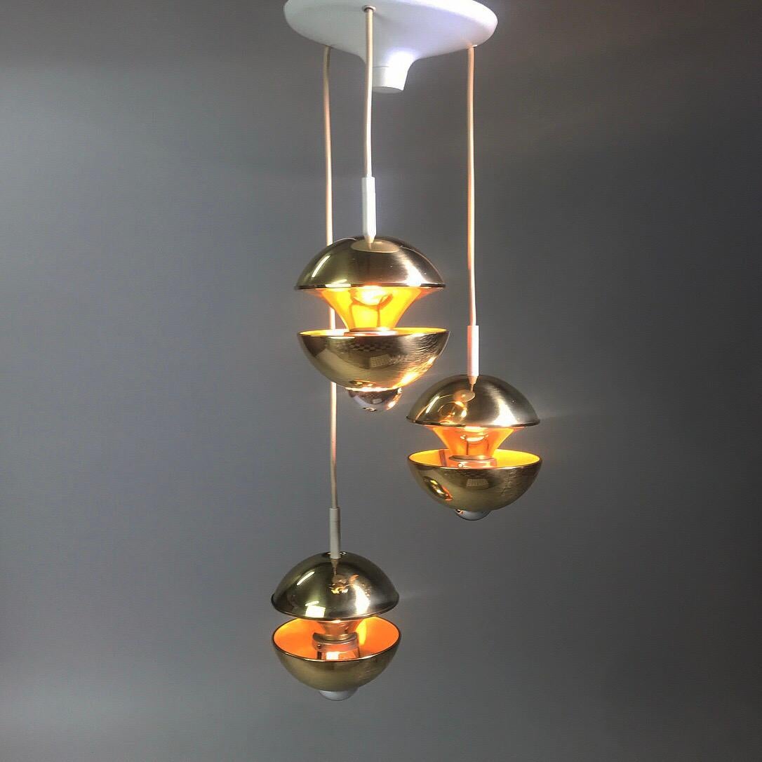 Beautiful golden brass chandelier with three light sources made by renowned lighting company Kaiser Leuchten, Germany, 1970s.

The rare piece is made of solid brass and due the the use of mirror bulbs (they designed the light to be used with
