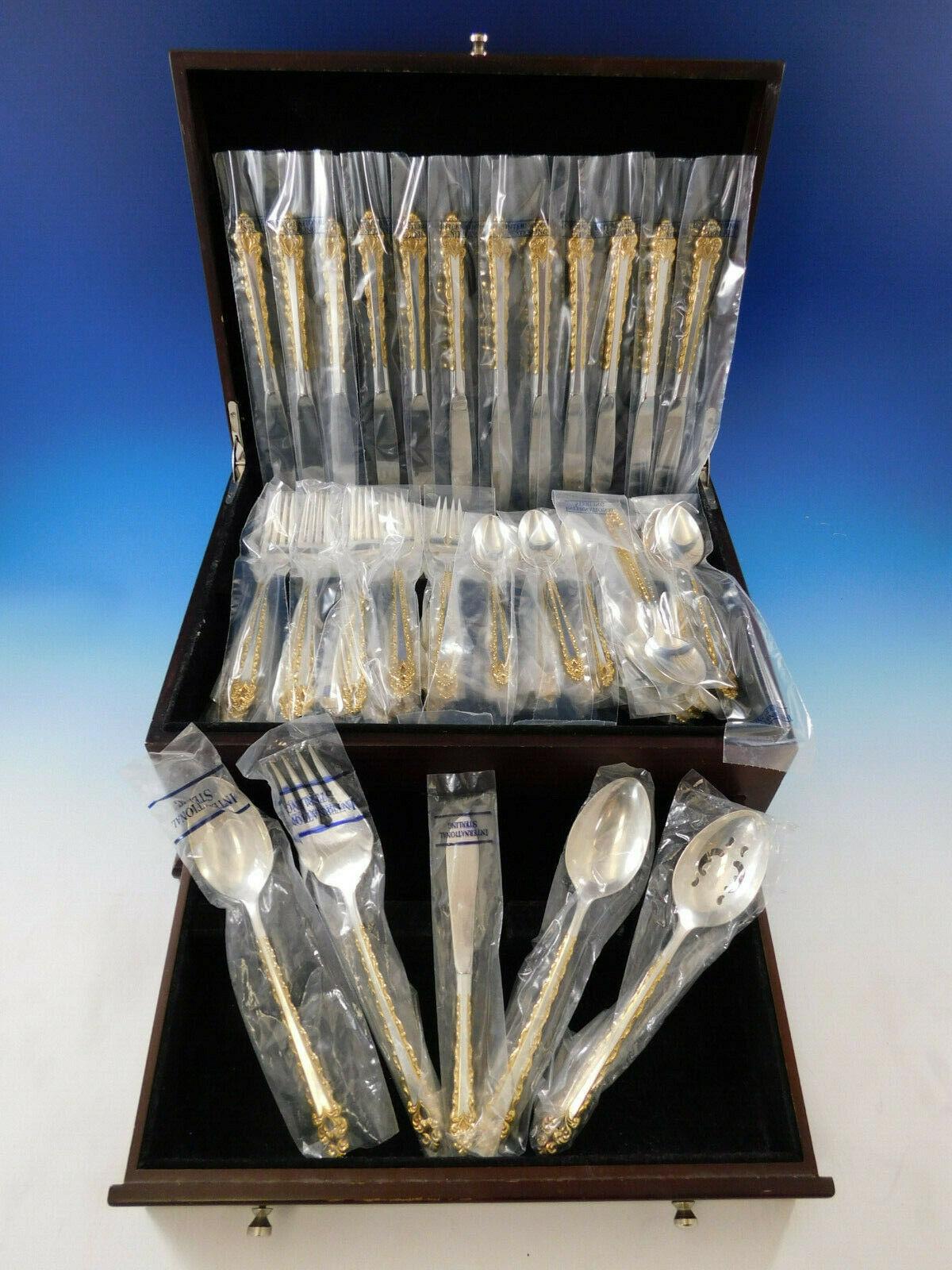 New, unused Golden La Strada by International sterling silver Flatware set with gold accents, 65 pieces. This pattern was introduced in the year 1972 and was discontinued in 2001. This set includes:

 12 place knives, 9 1/4