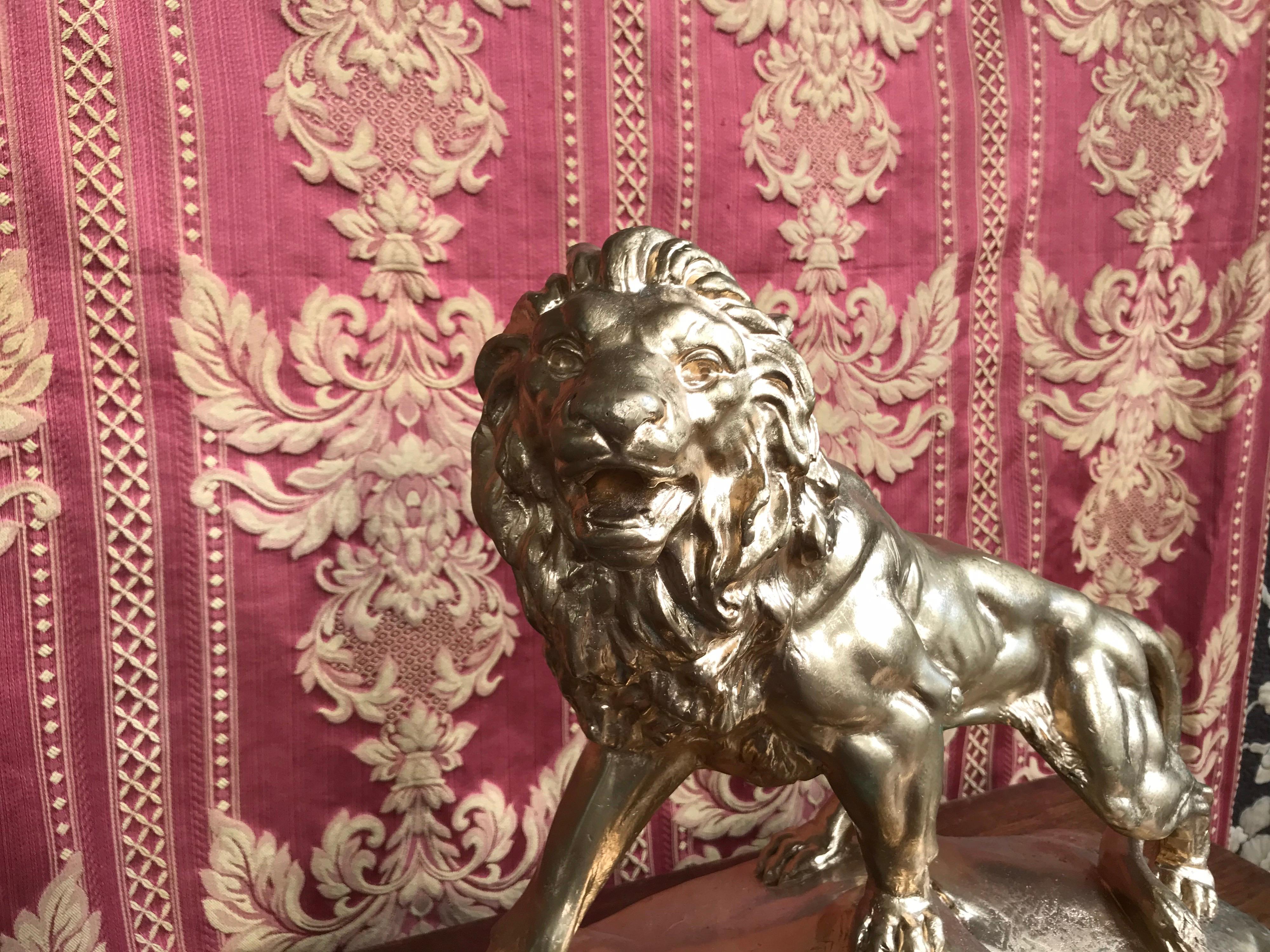 Beautiful lion standing on a rock, its mouth half open ready to roar.
Golden plaster
1950s work.