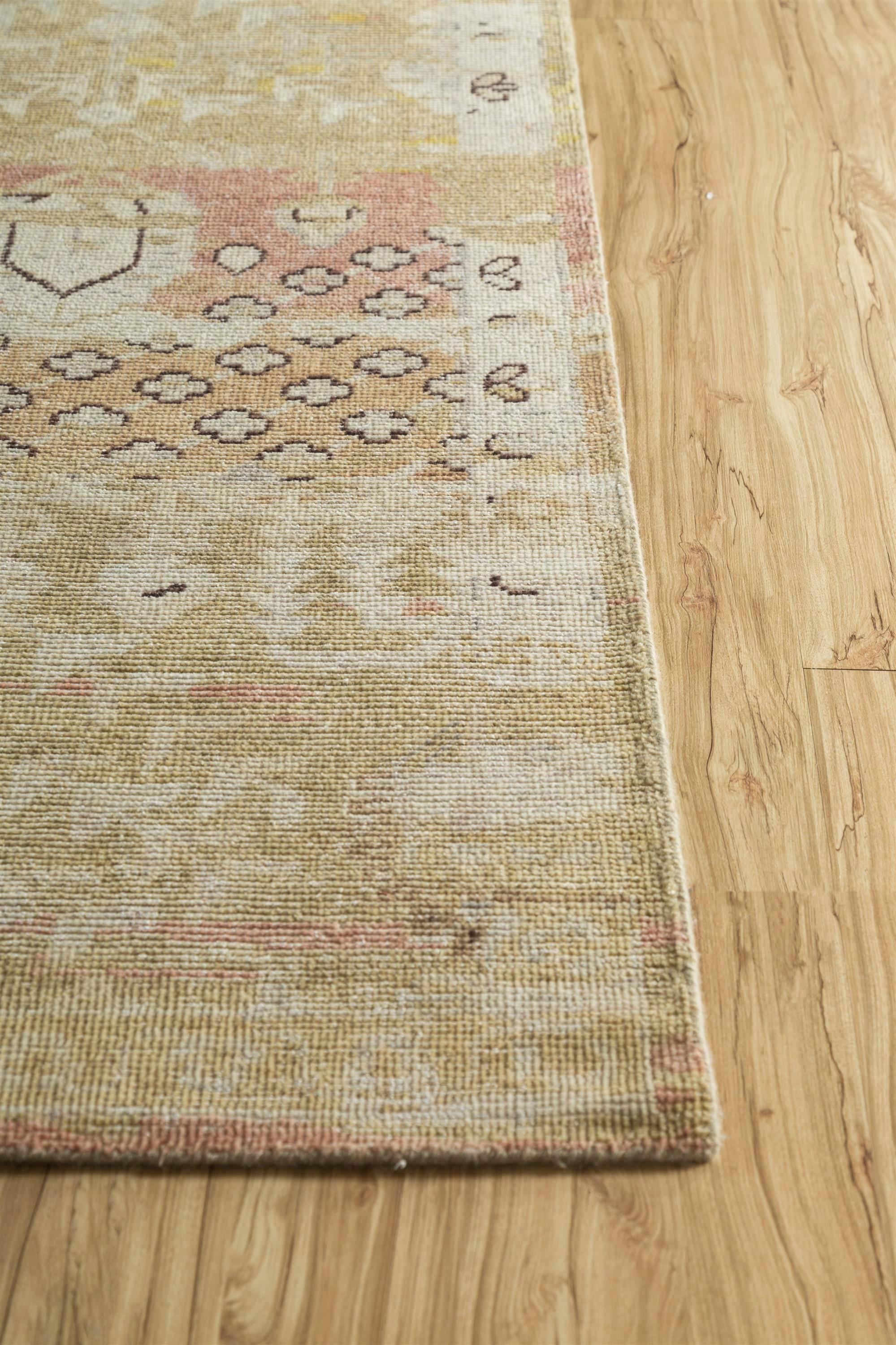 Immerse your space in the warm embrace of this heirloom-quality handknotted rug , meticulously crafted from high-quality wool. The ground color, a rich spice brown, intertwines seamlessly with a border of bright gold, creating a tapestry inspired by