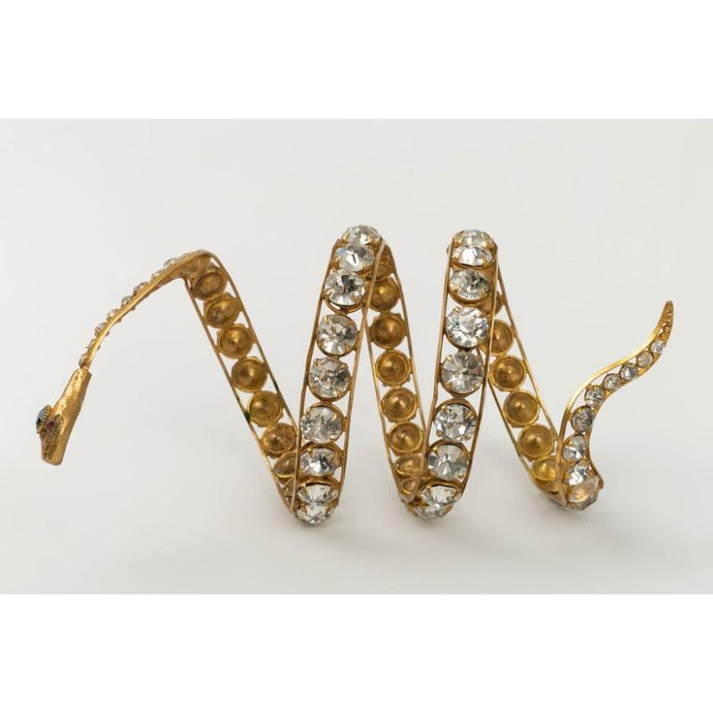 Not Signed - Golden metal snake bracelet paved with rhinestones. Unsigned cabaret jewel dating from the 1920s.

Additional information:
Condition: Good condition
Dimensions: Height: 16 cm - Circumference: about 22 cm
Period: 20th Century

Seller
