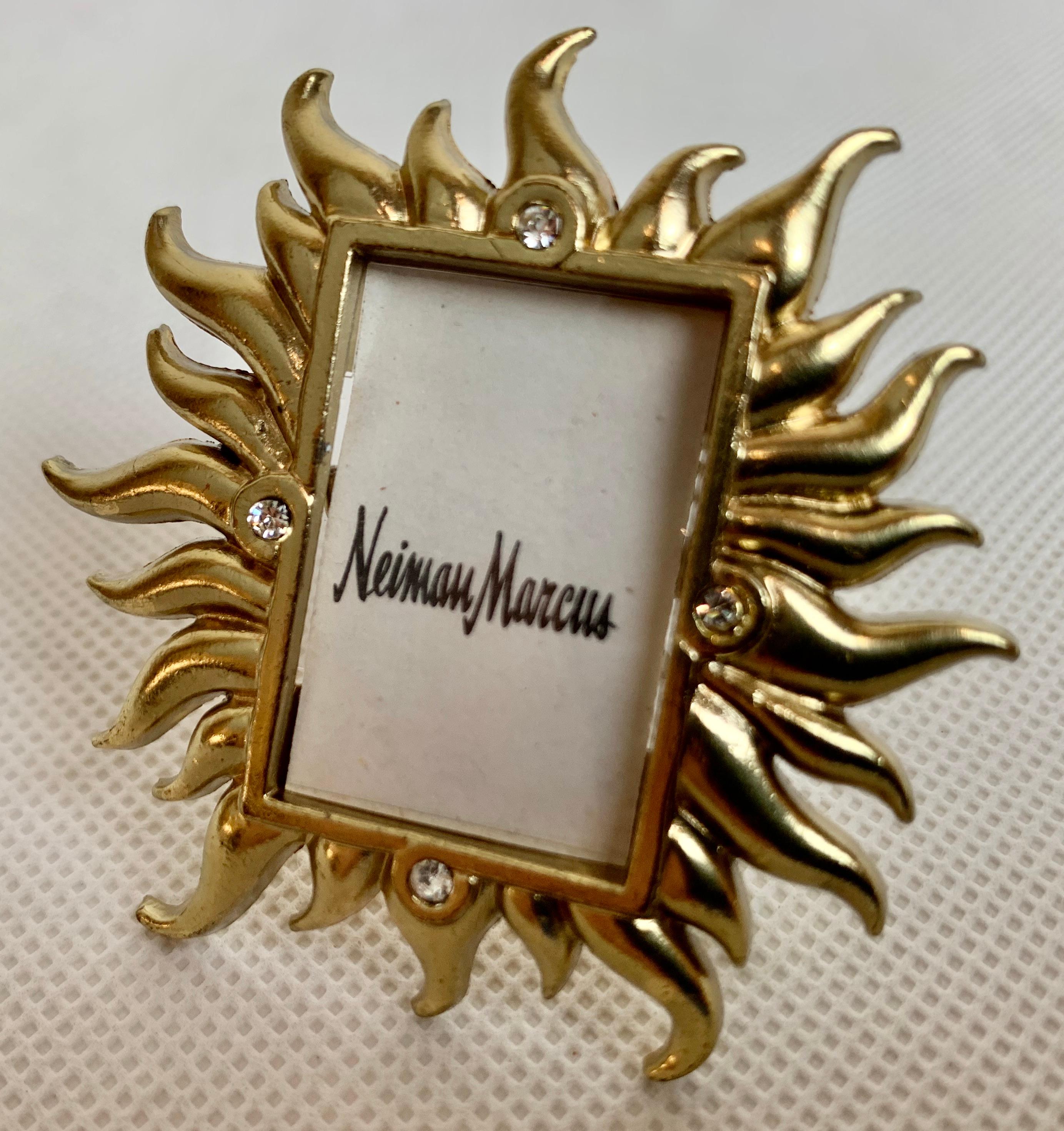 Jay Strongwater's mini golden sunburst frame for Neiman Marcus with Swarovski crystals was produced as a limited edition. It can be put on a flat surface with a photo. The back of the frame also has a strong clip that can be attached to any article