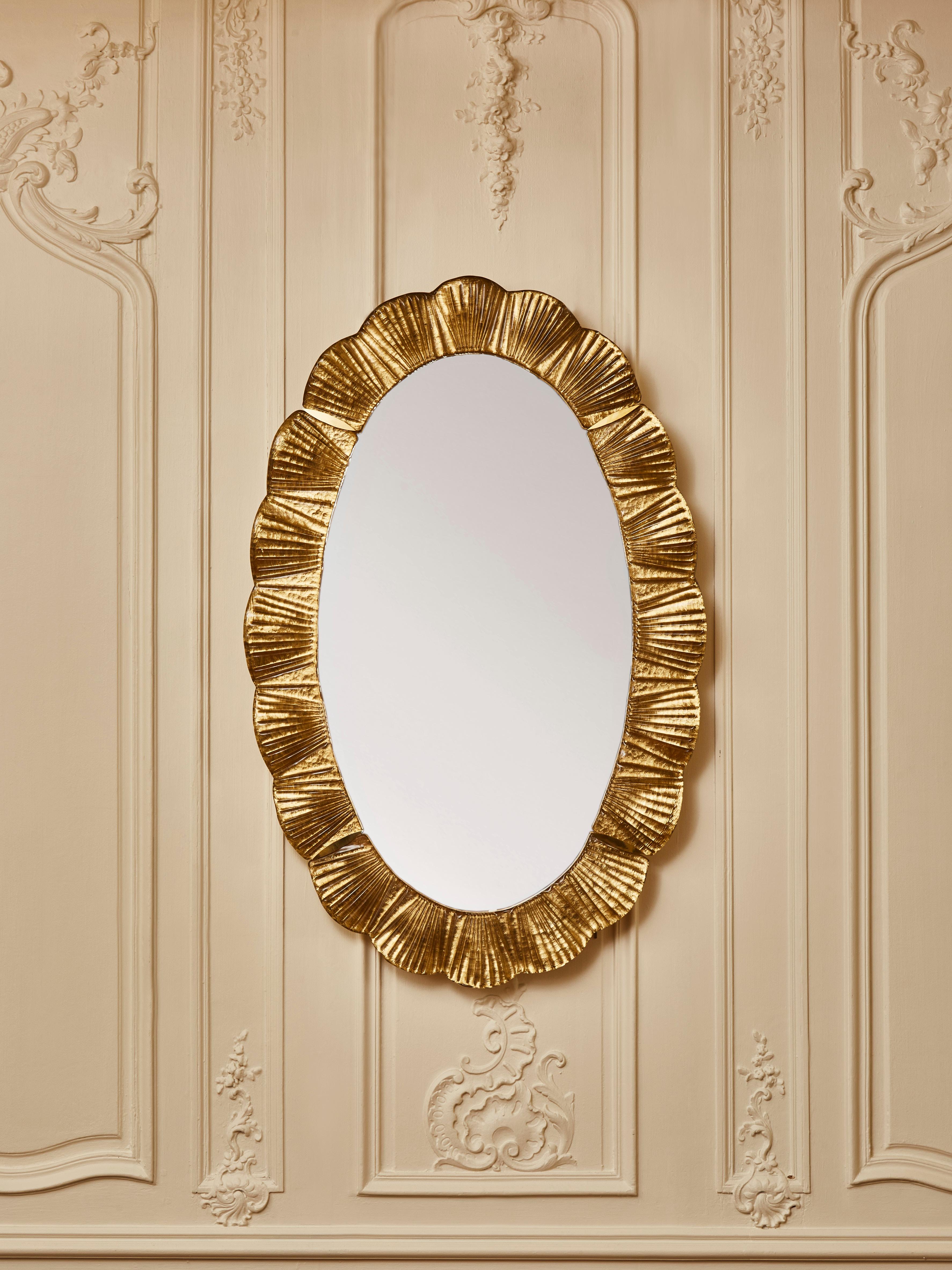 Elegant wall mirror with frame in sculpted and tainted Murano glass.
Creation by Studio Glustin. 
Italy, 2022.