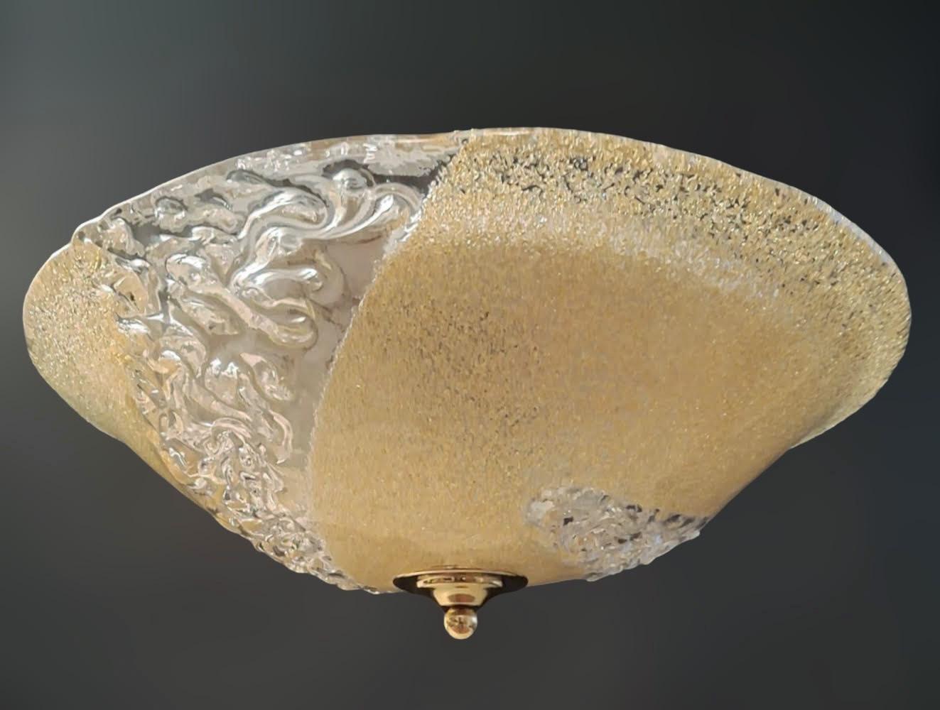 Italian flush mount with a Murano glass diffuser partially hand blown in amber graniglia and partially in clear texture, mounted on white metal frame / Made in Italy circa 1960s
Measures: diameter 20 inches, height 7 inches
2 lights / E26 or E27