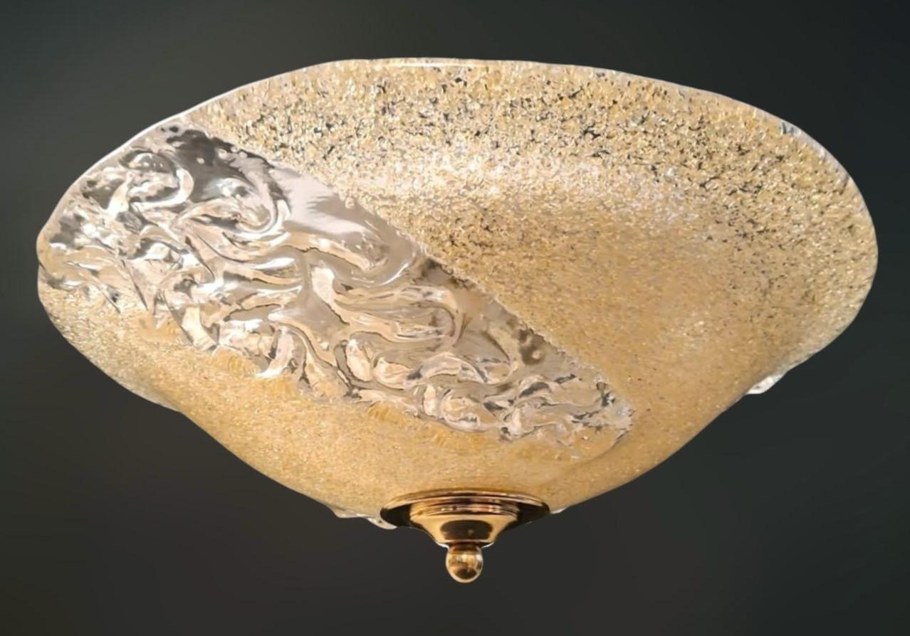Italian flush mount with a Murano glass diffuser partially hand blown in amber graniglia and partially in clear texture, mounted on white metal frame / Made in Italy circa 1960s
Measures: diameter 14 inches, height 5 inches
2 lights / E26 or E27