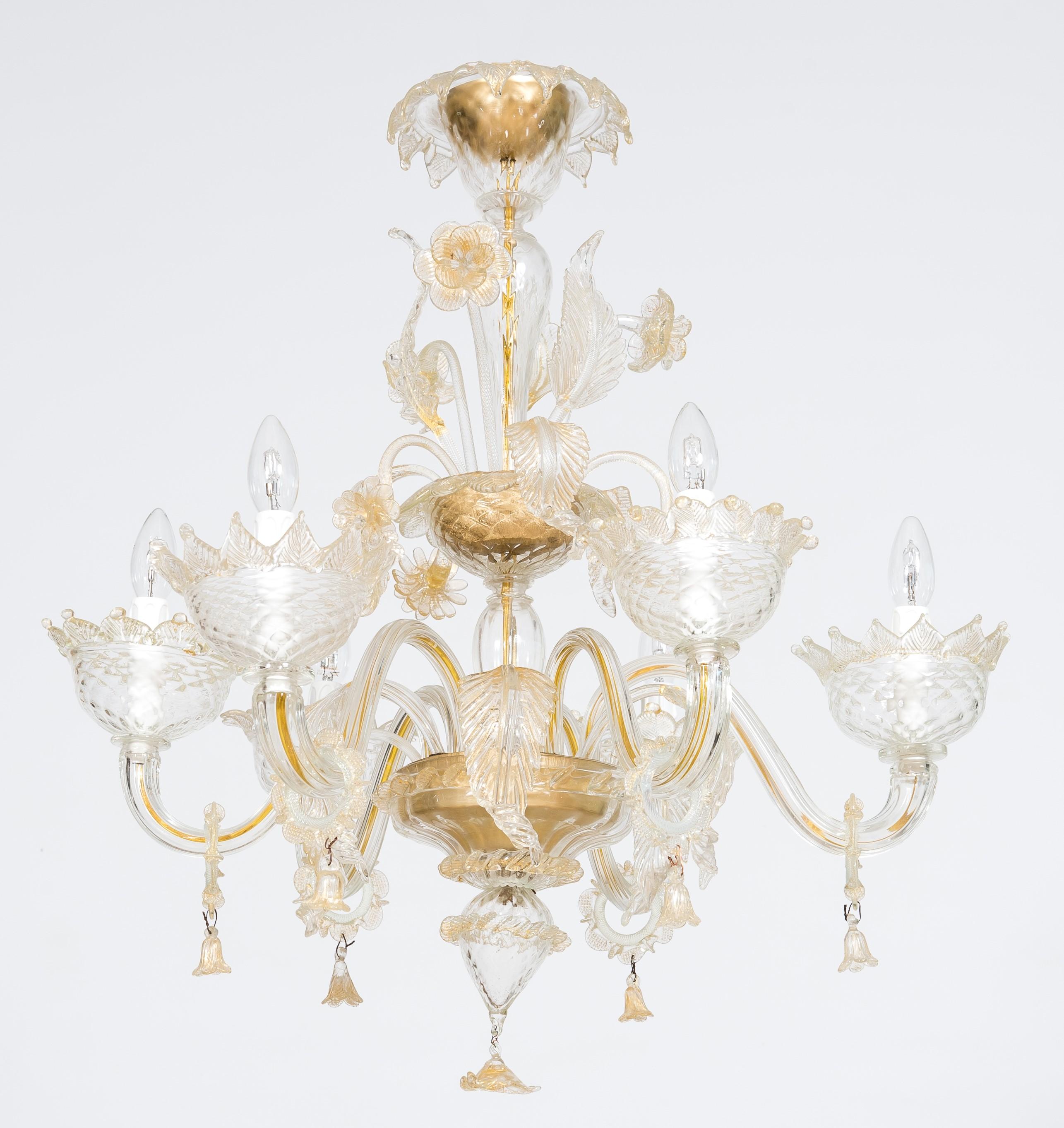 Golden murano glass chandelier with “Vere” decorations, 20th century, Italy.
This extraordinary chandelier was entirely made in the island of Murano, Italy, following the ancient glassmaking techniques. This masterpiece is rich in details and it is