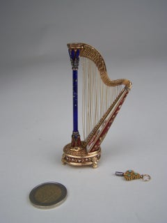 Golden Musical harp with enamel and precious stones by Köchert AE.