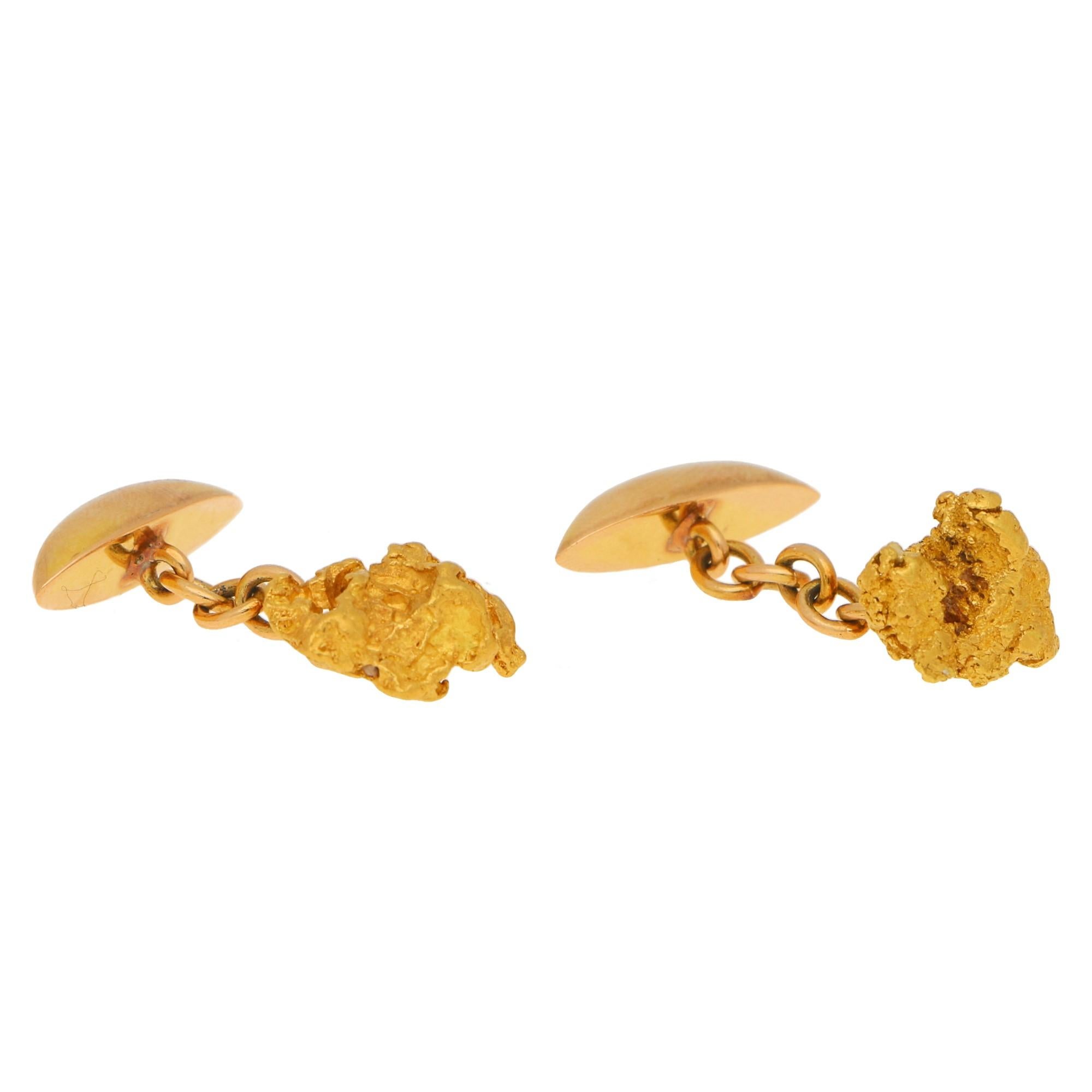 An unusual pair of hand crafted cufflinks with a rough ingot (gold nuggets) linked by chain to a torpedo style link with a flat back. 

What makes these cufflinks so marvellous is that parts of the host rock can be seen in some cavities in the