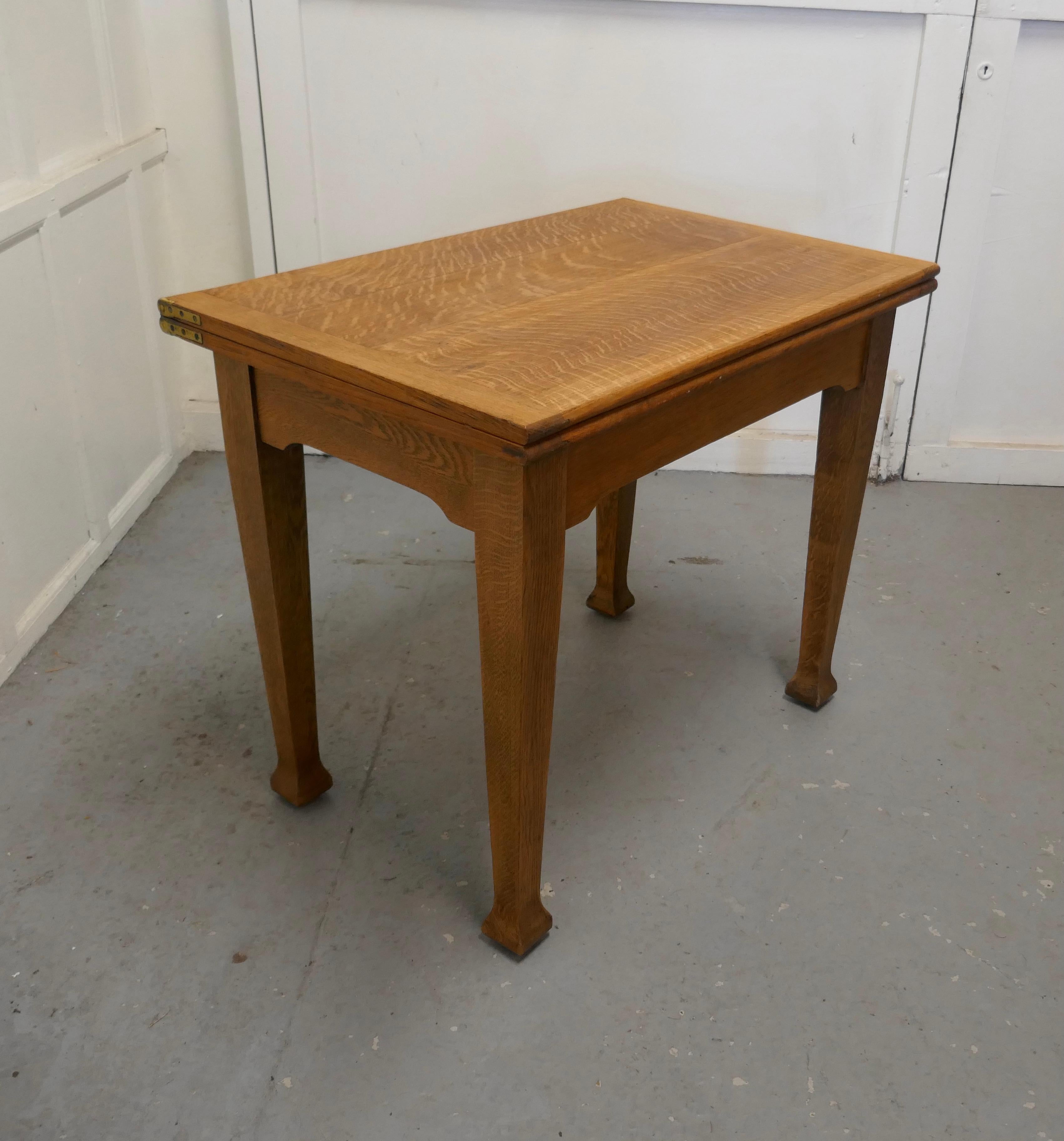 Golden oak Arts & Crafts Bachelor’s Metamorphic dining table

This is an unusual piece, the table is a neat rectangular occasional table with the added advantage that the top can be folded over to make decent size dining table which will seat 4