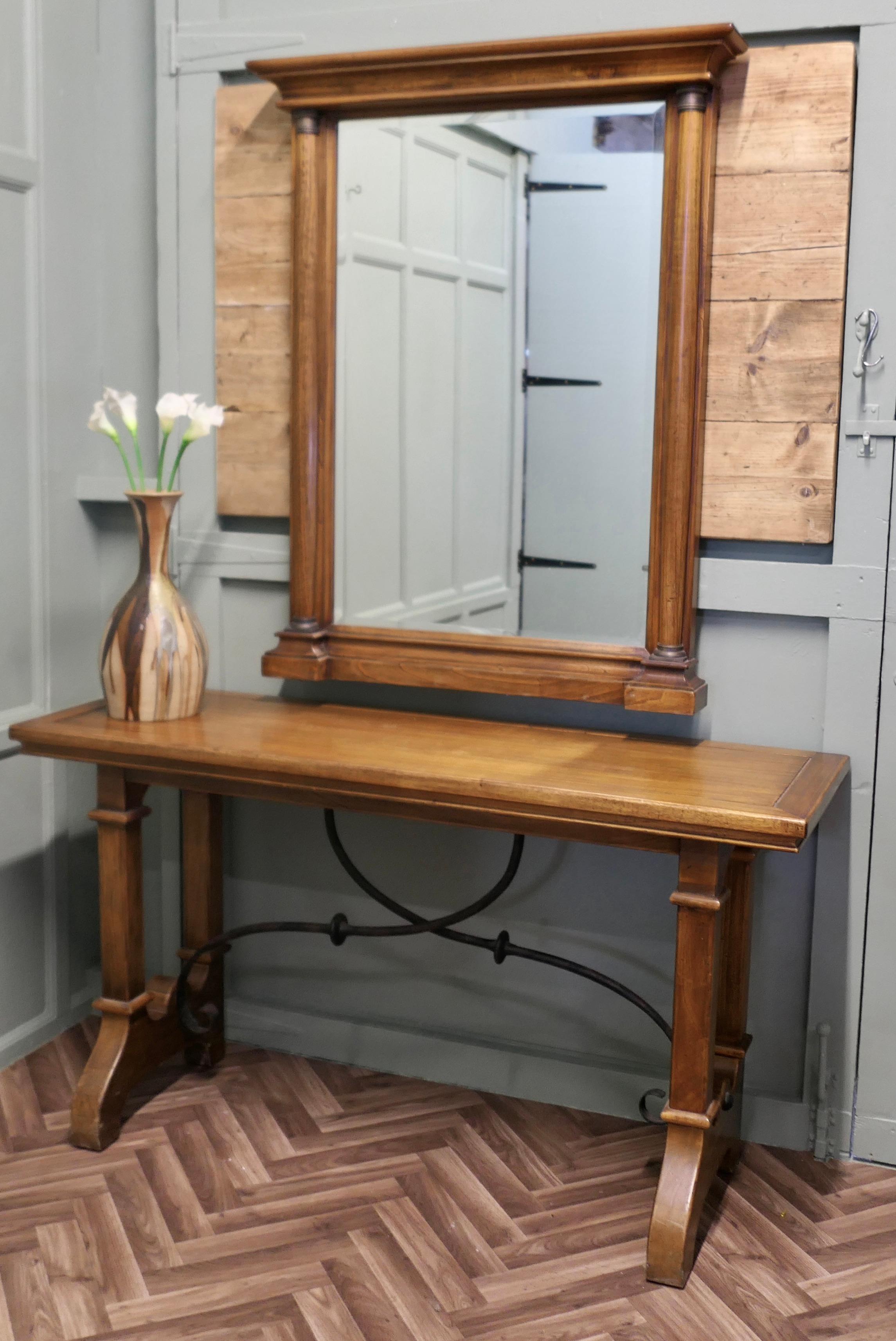 Golden Oak Arts and Crafts Console and Mirror

This set consists of a tall Mirror in Golden Oak with a little brass decoration on the columns and a matching long narrow table with a curved iron stretcher
Both pieces are in good condition, 
Good