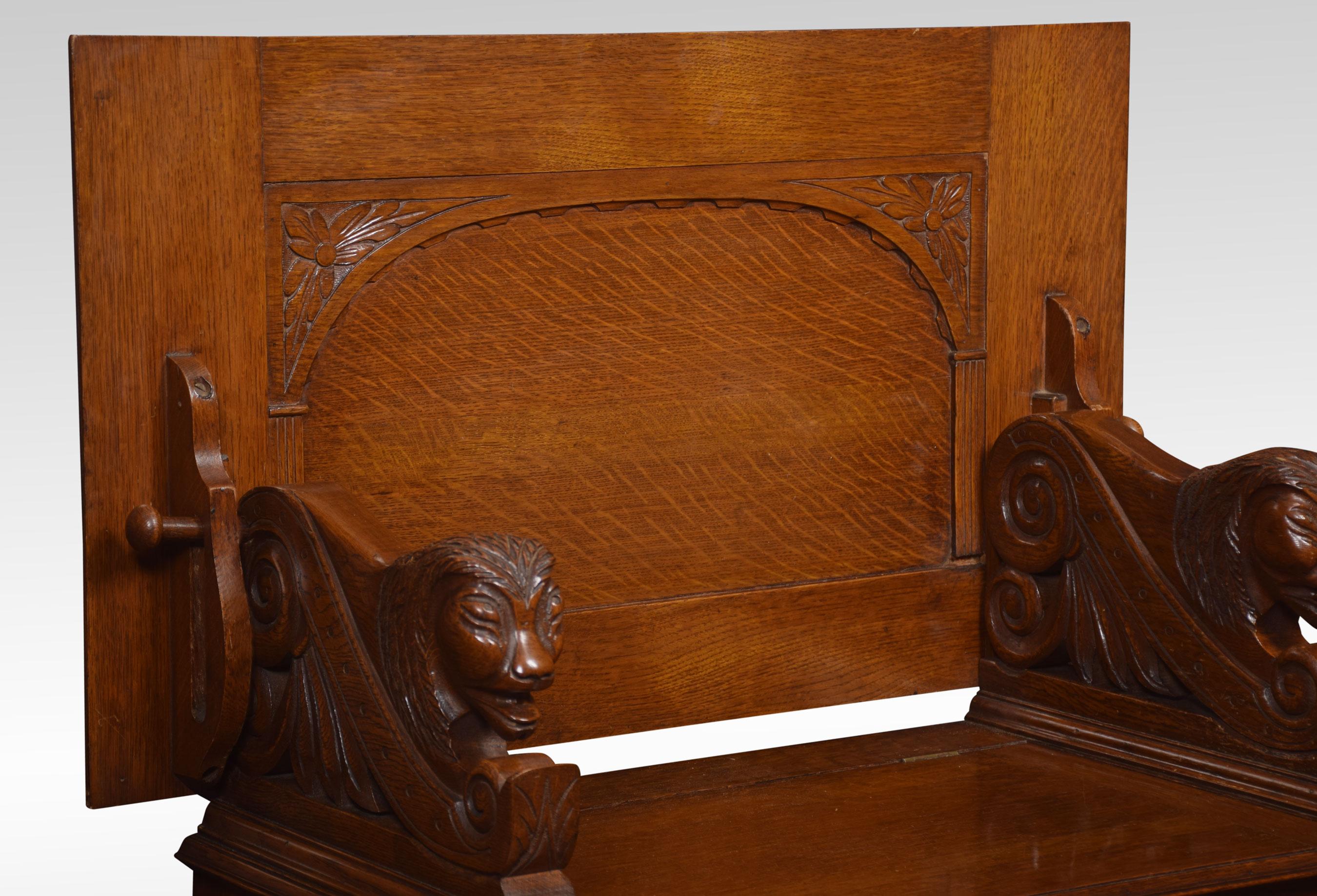 Oak monks bench of narrow proportions, the rectangular hinged floral carved back, above a box base with hinged lid flanked by a lion armrests. All raised up on bun feet.
Dimensions
Height 39 inches height to seat 18 inches
Width 36 inches
Depth