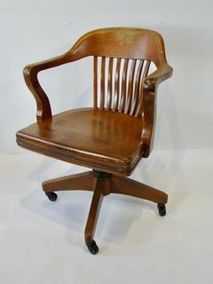 Golden oak swivel tilt English bankers desk or task chair in original finish