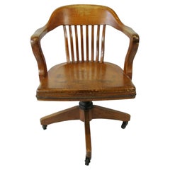 Golden oak swivel tilt English bankers desk or task chair in original finish