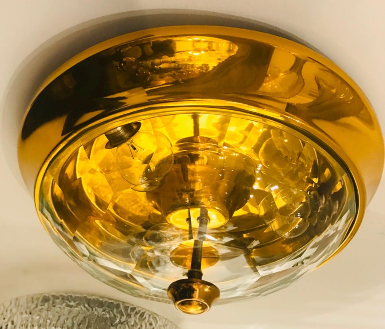 A wonderful 1970s Italian golden brass ceiling light with a thick faceted crystal shade designed by famed designer, Oscar Torlasco for Lumi.