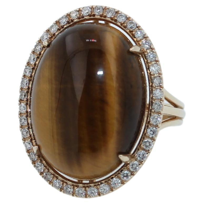 Golden Oval Tiger's Eye Cabochon Diamond Halo Cocktail 14 Karat Yellow Gold Ring
8.59 CTs Tiger Eye Cabochon Gemstone
0.65 TCW Diamonds
14K Yellow Gold
Ring Size 7 - Resizable Upon Request