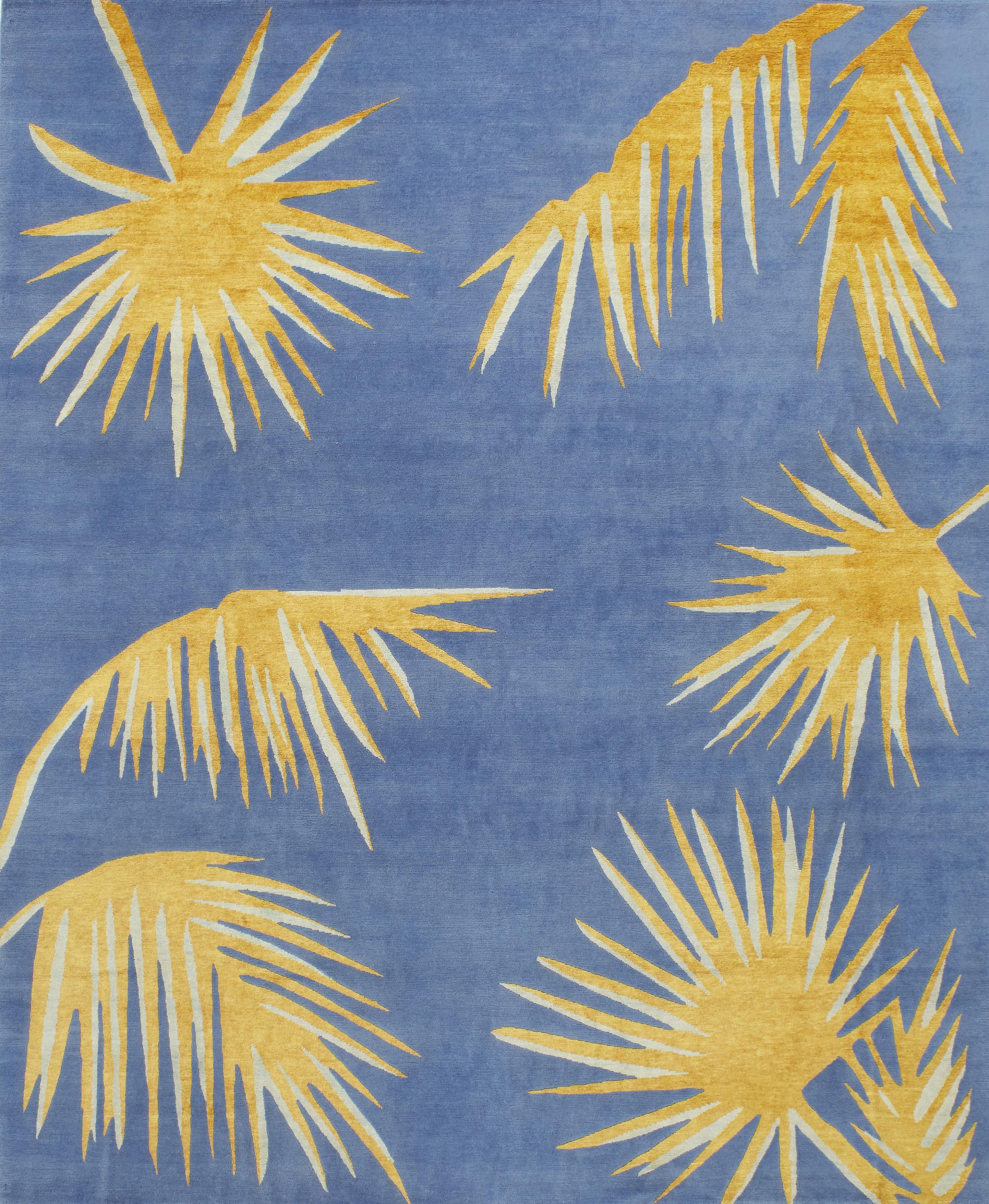 This exquisite rug was entirely hand knotted using Tibetan wool, which is highly durable and soft. The details are in Fine silk, to add a different texture to the piece. In it, pale-blue is the background for a set of striking golden-yellow palm