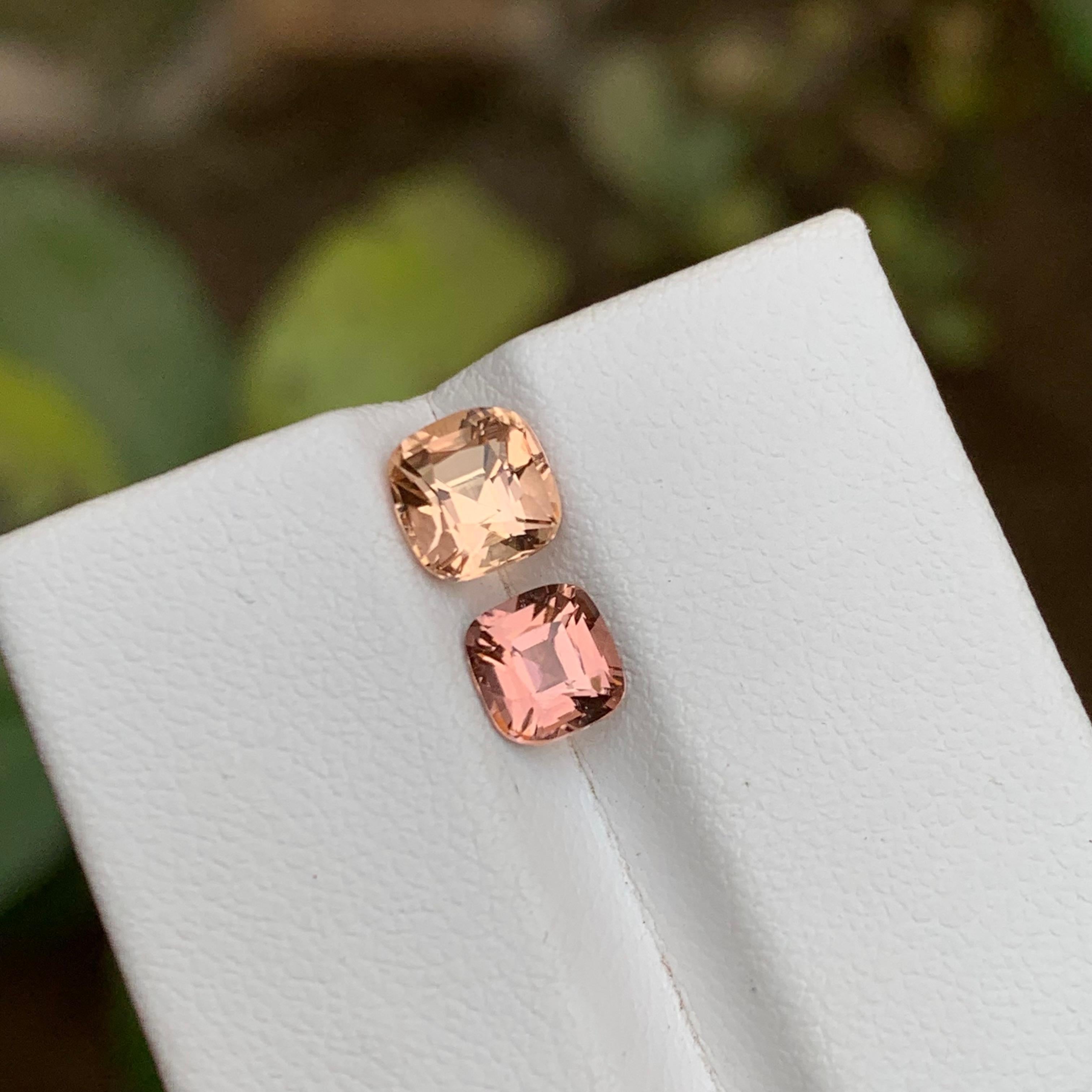 GEMSTONE TYPE: Tourmaline
PIECE(S): 2
WEIGHT: 2.05 Carats
SHAPE: Cushion
SIZE (MM):  1.25 Carat: 6.07 x 5.94 x 5.25
and 0.80 Carat: 5.56 x 5.32 x 3.88
COLOR: Golden Peach and Pink
CLARITY: Eye Clean
TREATMENT: Heated
ORIGIN: Afghanistan
CERTIFICATE: