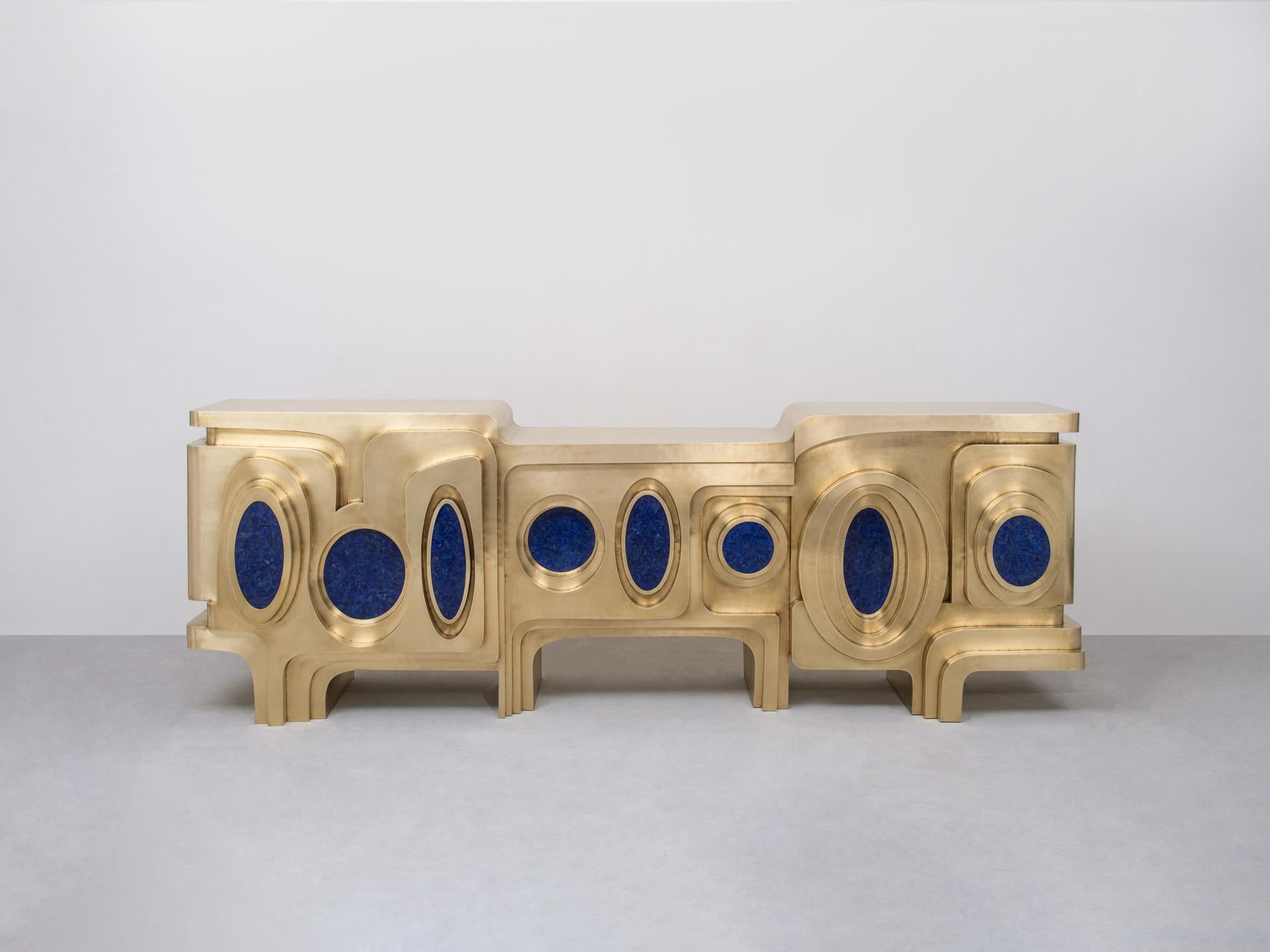 Evocative of a dancing peacock, this striking brass console is inlaid with semi-precious stones. It employs the studio’s distinct technique of hollowed joinery, in which brass sheets are hammered and joined together with great skill to create a