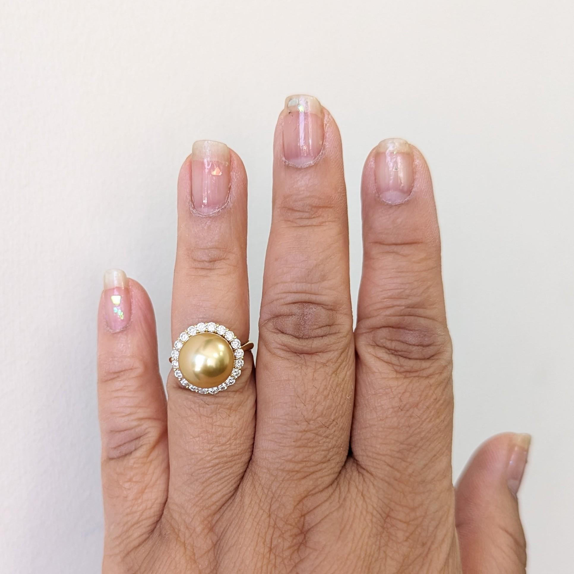 Beautiful big round golden pearl with 0.70 ct. good quality white diamond rounds.  Handmade in 18k yellow gold.  Ring size 6.25.