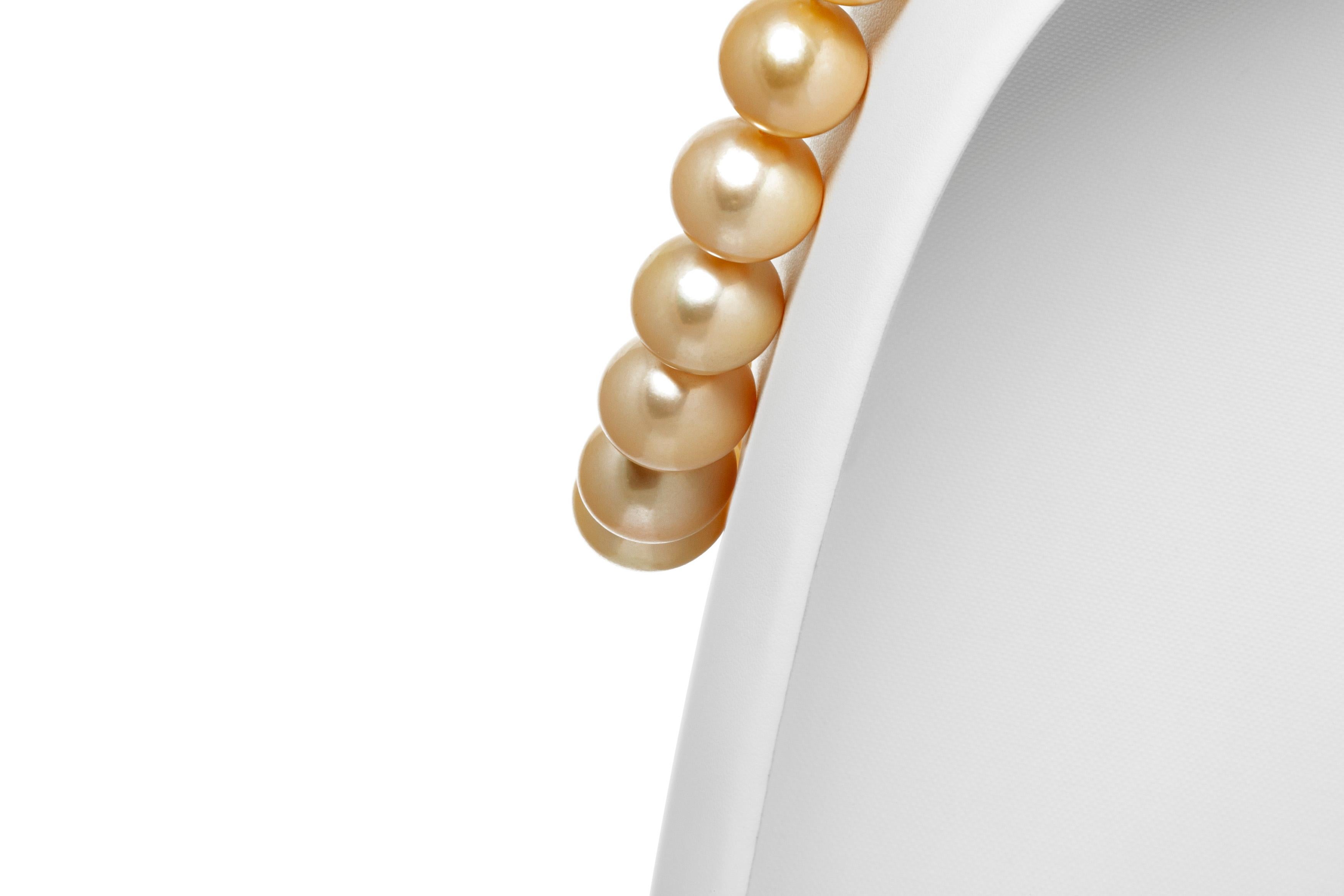 Pearl necklace, finely crafted in 18k yellow gold with diamonds weighing approximately a total of 1.50 carat. Size of the pearls is between 12mm - 12.5mm and 15.5mm - 16.00mm. Circa 2000.