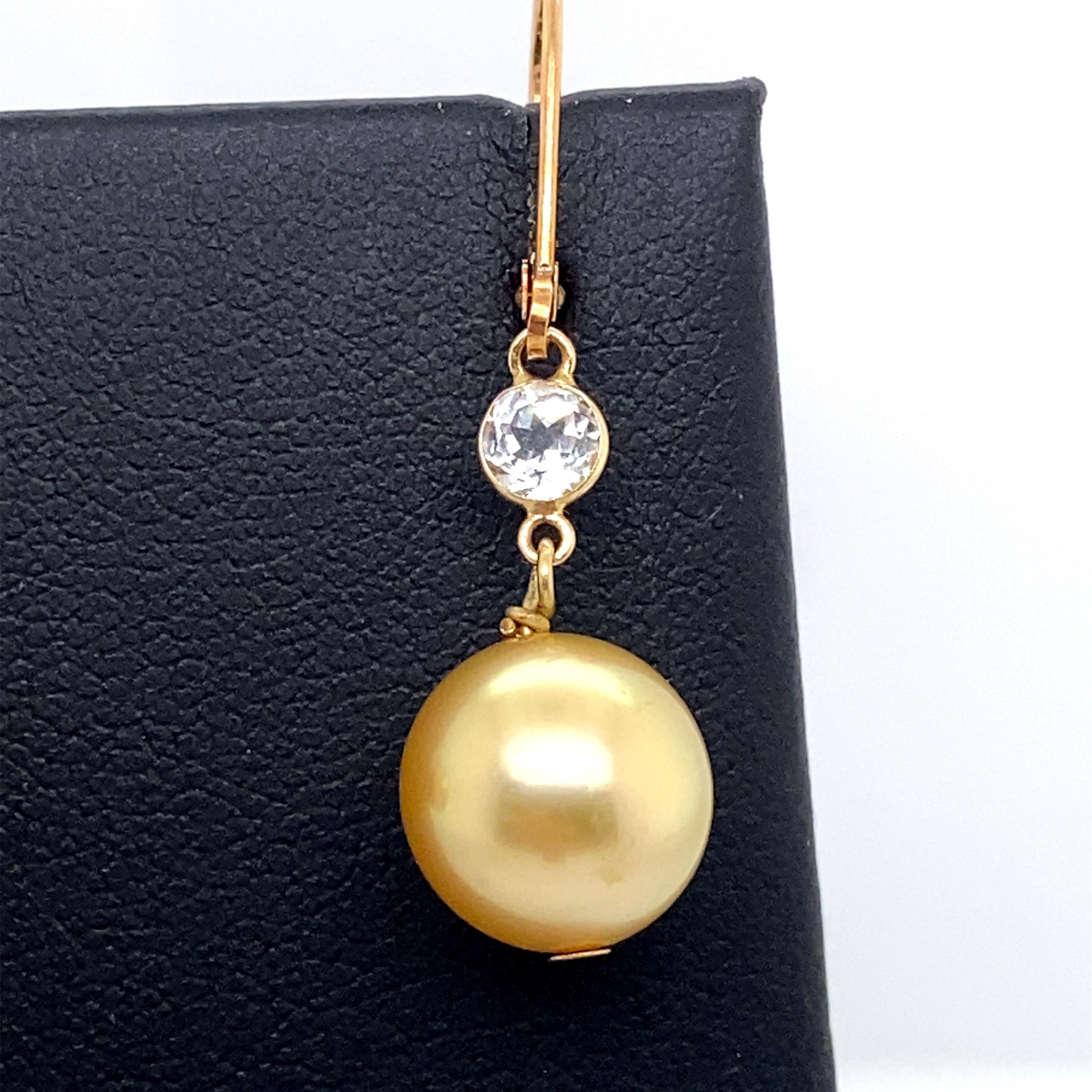 14K Yellow gold drop earrings featuring two golden pearls measuring 9-10 mm with round semi precious gemstones.  
Color G-H
Clarity SI