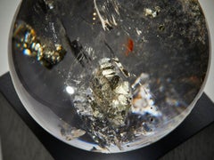Golden pyrite in quartz sphere