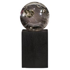 Golden pyrite in quartz sphere