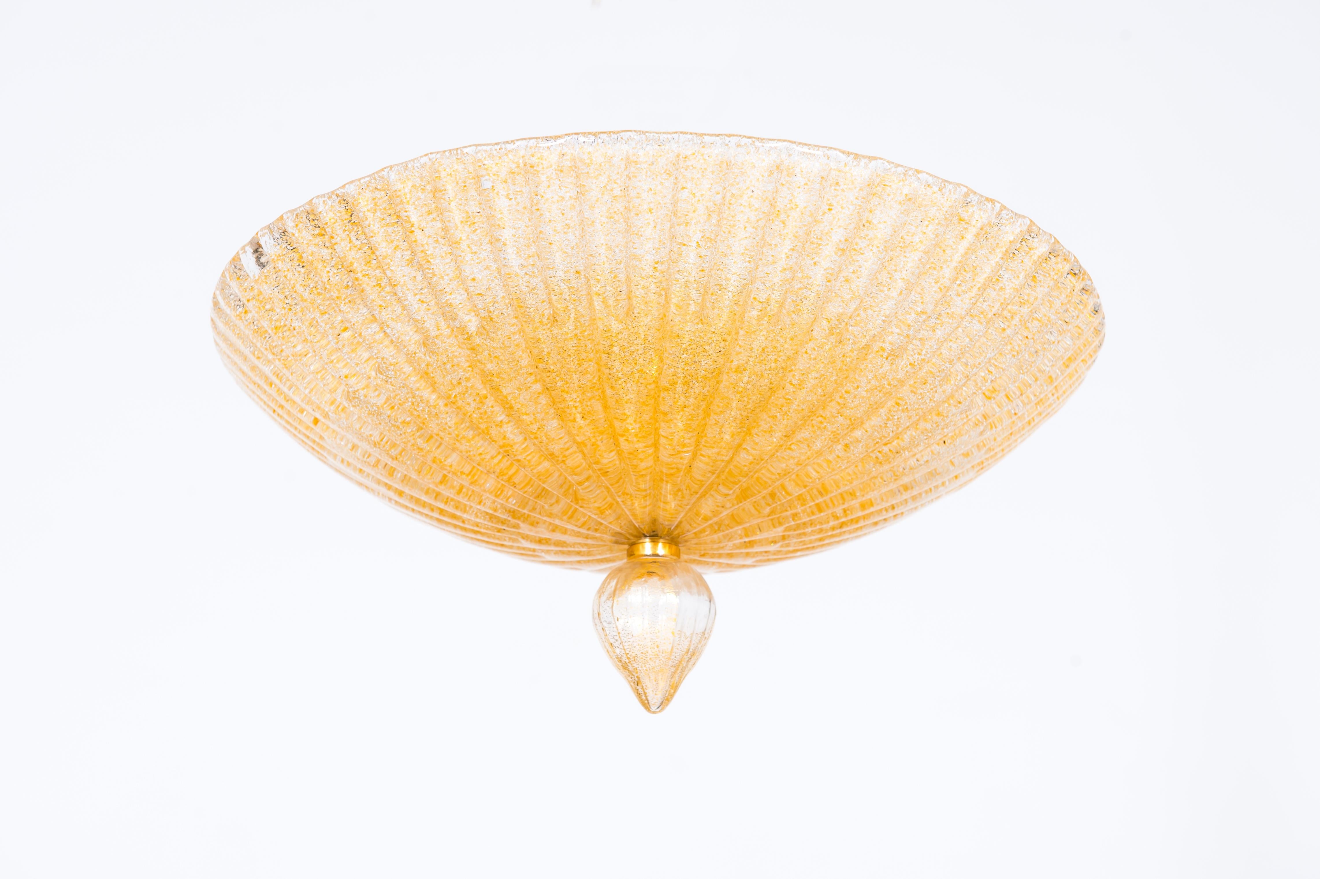 Golden Rays Flush Mount in Sprinkled Amber Blown Murano Glass Venice Italy 1980s
This shining bright flush mount dates back to the 1980s. Handcrafted in Murano, the Venetian island renowned for the finest tradition of glassmaking, it is attributed