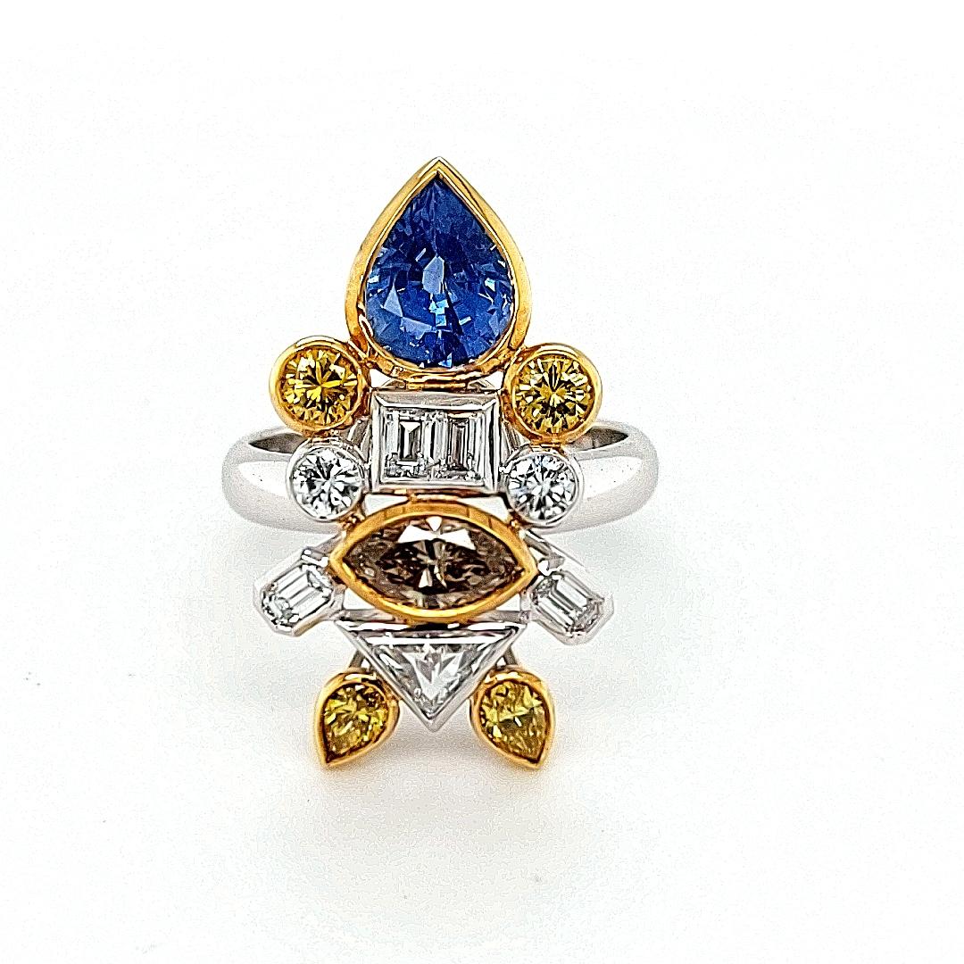 Unique and handcrafted beautiful ring depicting a fish set with diamonds and sapphires.

Diamonds & Fancy color diamonds : baguette cut, emerald cut, brilliant cut, triangle cut together 2.03 carat.

Sapphires: Pear shape natural Ceylon sapphire
