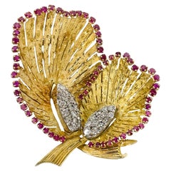Spilla floreale in rubino dorato e diamanti.