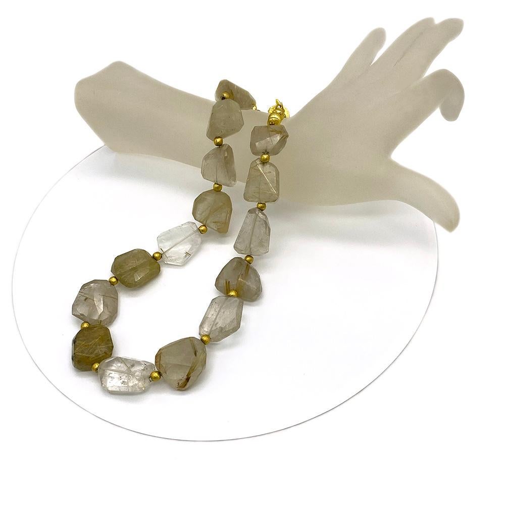 This is a golden rutilated quartz necklace with up to 20 x 24 x 18 mm chunky asymmetrical faceted nugget shaped gemstones with 22k gold plated copper components and an easily managed detailed pattern Bali style magnet clasp. This strand of fifteen