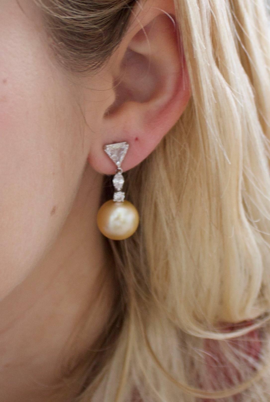 Golden South Sea Pearl and Diamond Earrings in 18k Gold
Two Golden South Sea Pearls 13 mm
Two Triangle Cut Diamonds weighing 2.02 carats
Two Round Brilliant Cut Diamonds weighing .30 carats
Two marquise Cut Diamonds weighing .50 carats