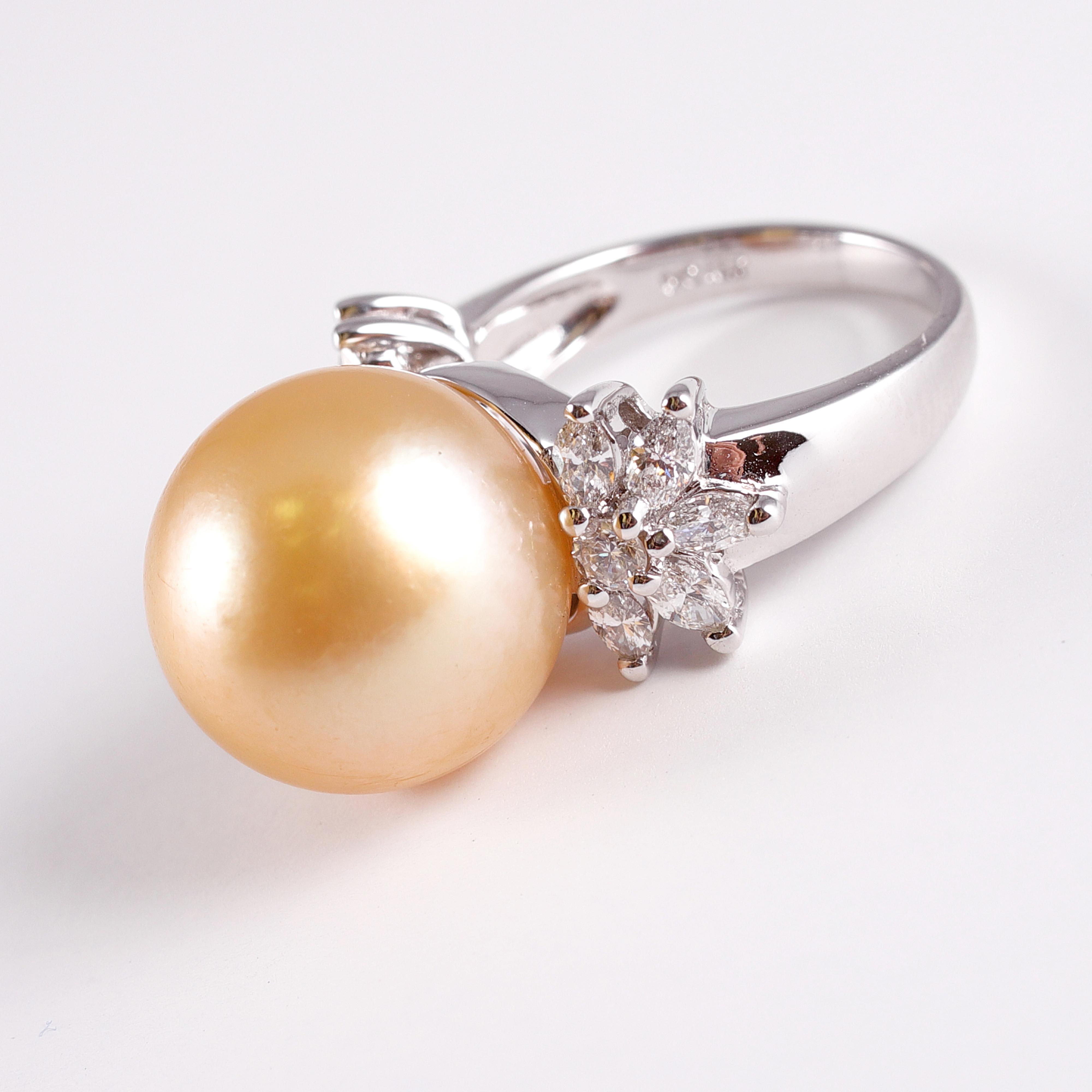 Golden South Sea Pearl measuring 14.68 millimeters accented by .87 carats of round and marquis diamonds.  This elegant ring is 18 karat white gold and is a size 6 1/2.