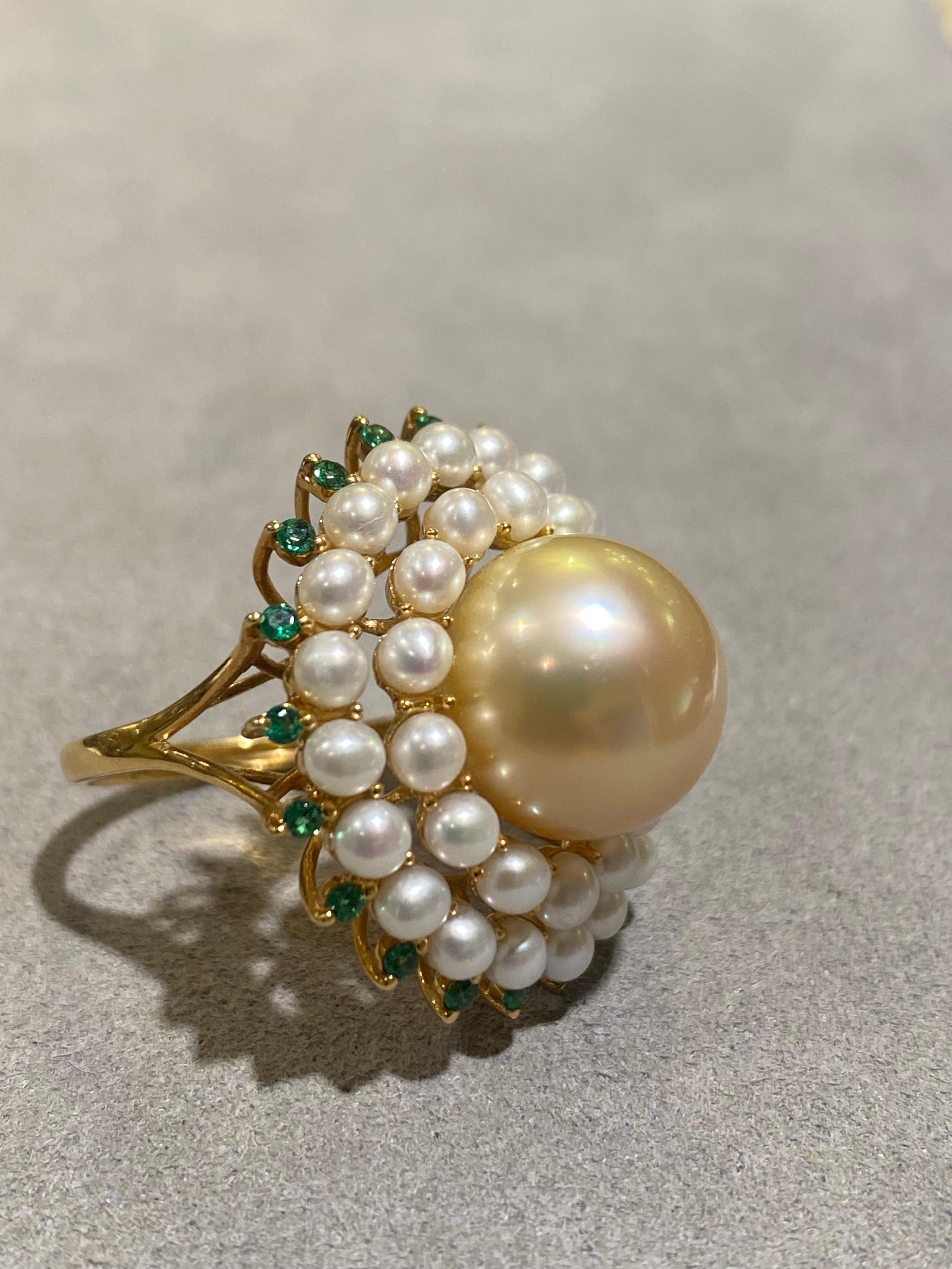 A 12.5 mm light gold colour south sea pearl is surrounded by 2 layers of small white seed pearls in a descending circle. It is a big yet elegant cocktail ring for any occasions. 

The colour of the pearl is light gold with pink overtone. The pearl