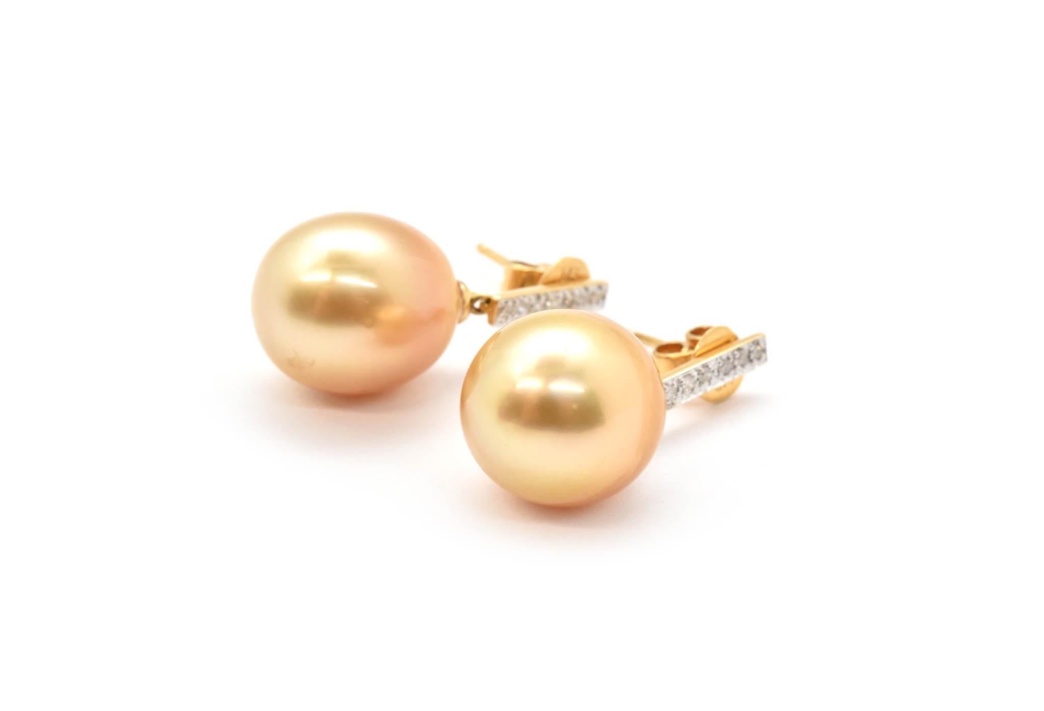 Each golden pearl dangles off each earring with 0.14cttw diamond accents, the gold accent has a post attached to it and has a friction back. The diamonds are H in color, and SI in clarity. These earrings weigh 8.21 grams. 
