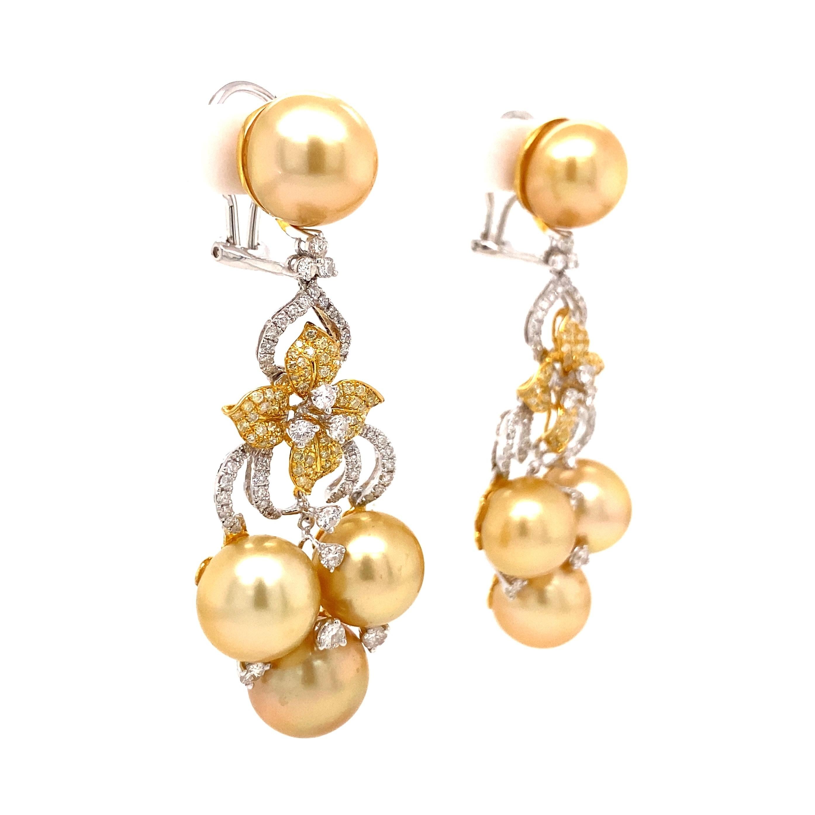 
Simply Beautiful Golden South Sea Pearl and Diamond Drop Earrings. Each earring Hand set with 5-11.5mm South Sea Pearls and accented with  White and Fancy Yellow Diamonds, approx. 2.27tcw Hand crafted 18K Yellow Gold and White Gold mounting.