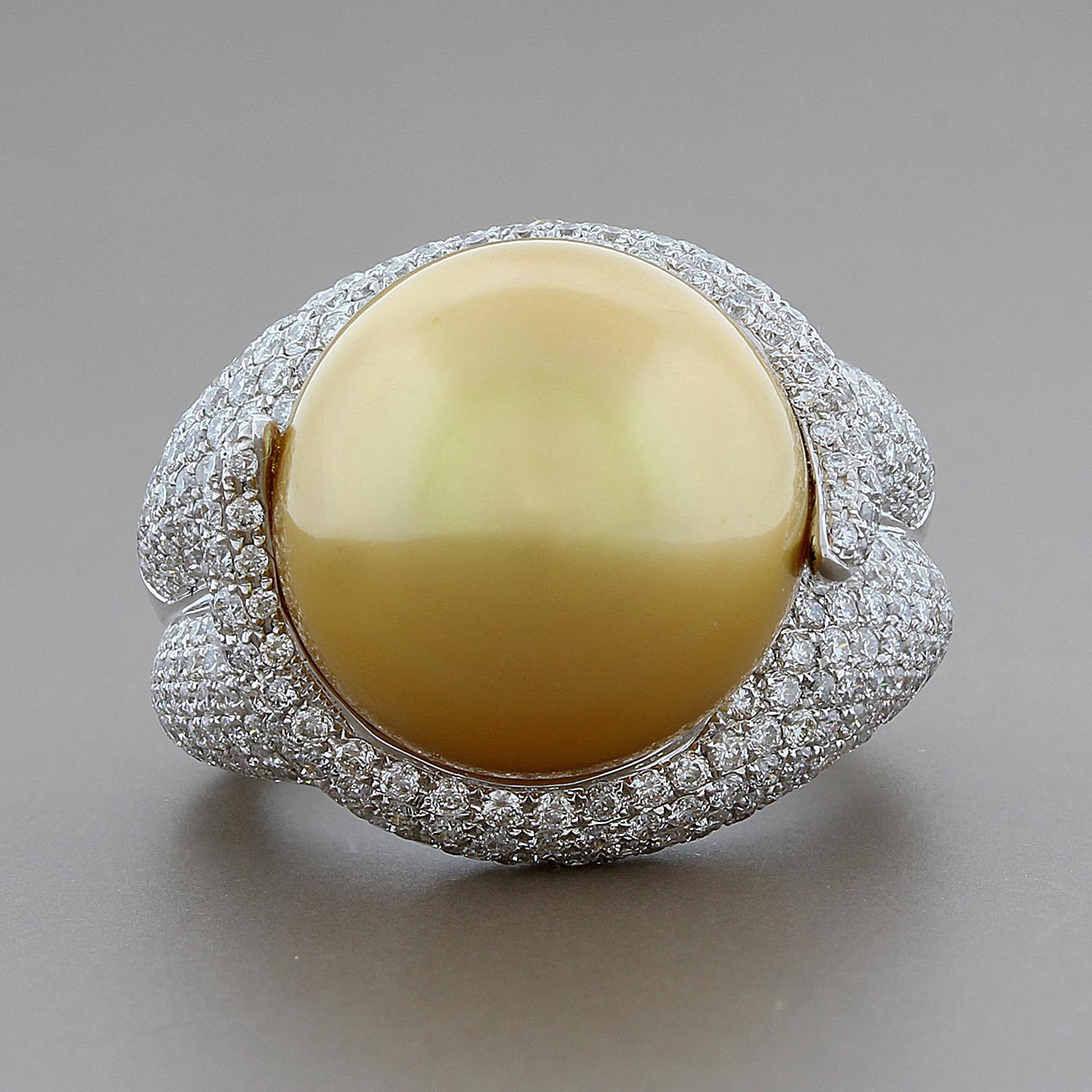 A diamond gold ring featuring a lustrous golden South Sea pearl measuring 15mm, just about the largest they come! The gold ring is covered with 2.29 carats of fine VS quality round cut diamonds, set in 18K white gold. 
Size 6 ¾ 
