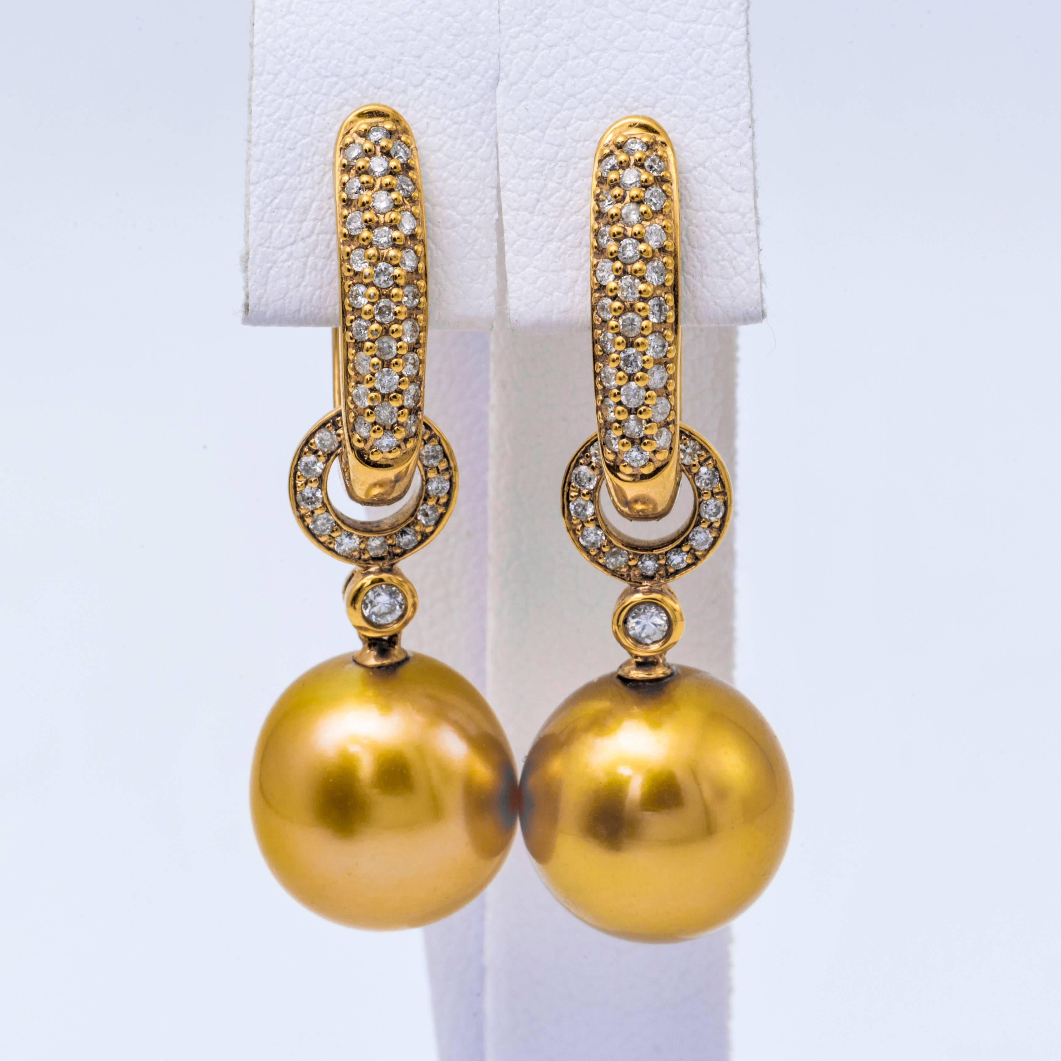 18K Yellow gold drop earrings featuring two Golden Pearl measuring 11-12mm flanked with round brilliants. 

Pearl Quality	AAA
Luster	AAA, Excellent
Nacre	Very Thick
