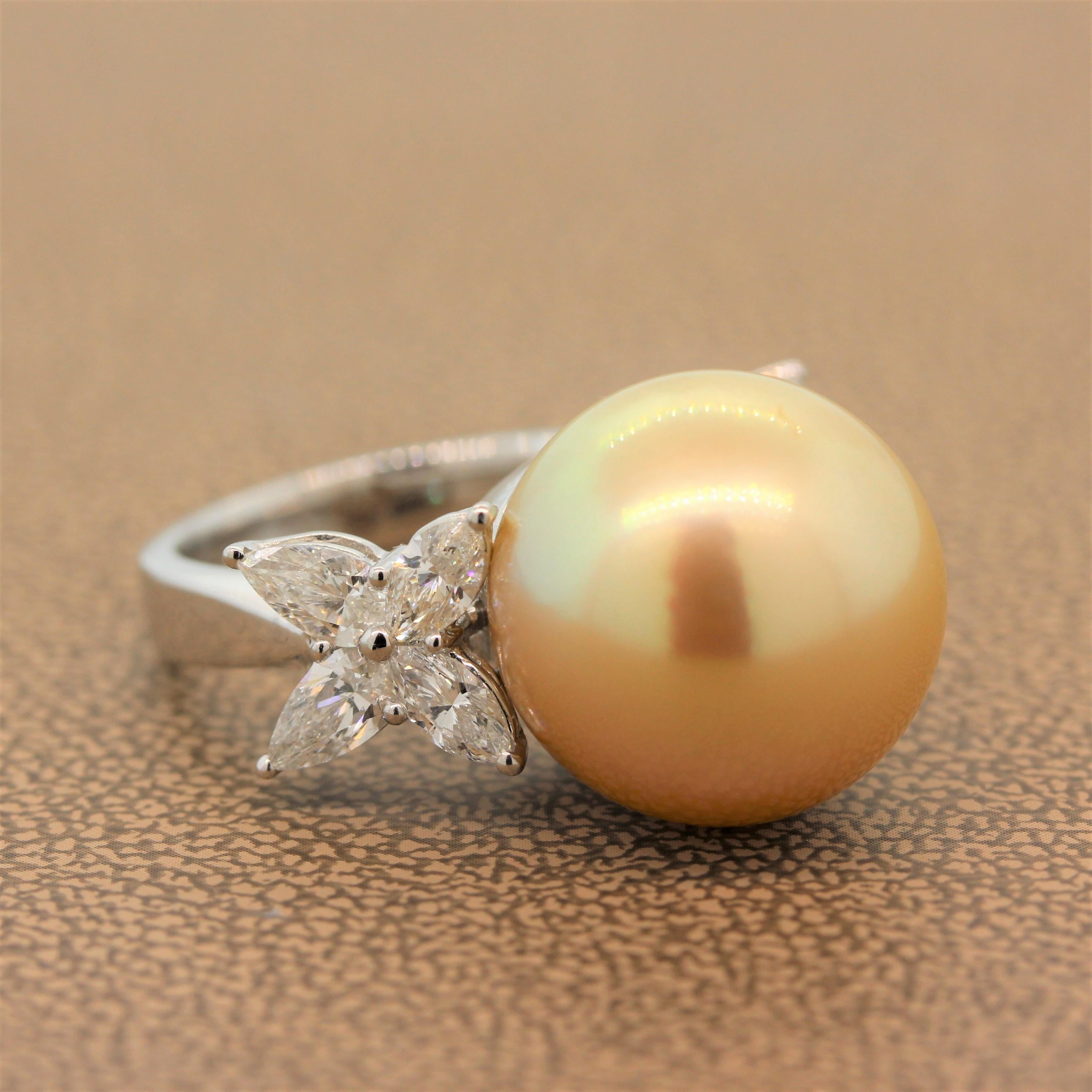 A lustrously shining 16.5mm golden South Sea pearl sits between two clusters of 1.70 carats of diamond clusters of marquise cut and pear cut diamonds. This indulgent ring is set in 18K white gold.

Ring Size 6.5 (Sizable)
