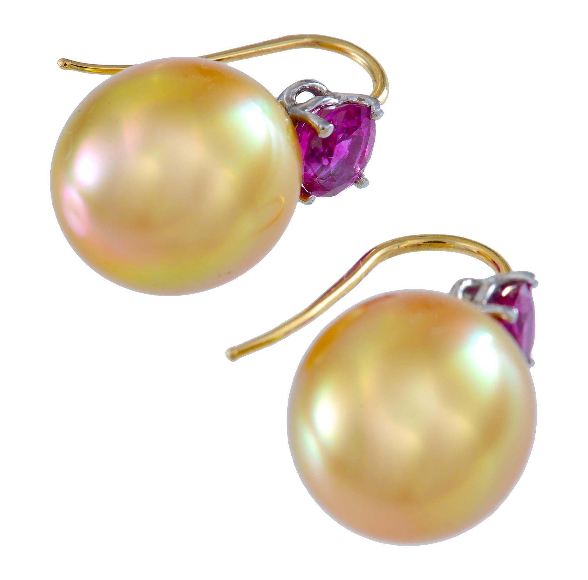 A sensational hand crafted pair of tear drop shaped  Golden South Pearl earrings of 12.44mm and 12.5mm with wonderful clean lustrous skins and  each surmounted with a deep rose coloured Burma ruby with a total weight of 1.57 cts. The Rubies are set