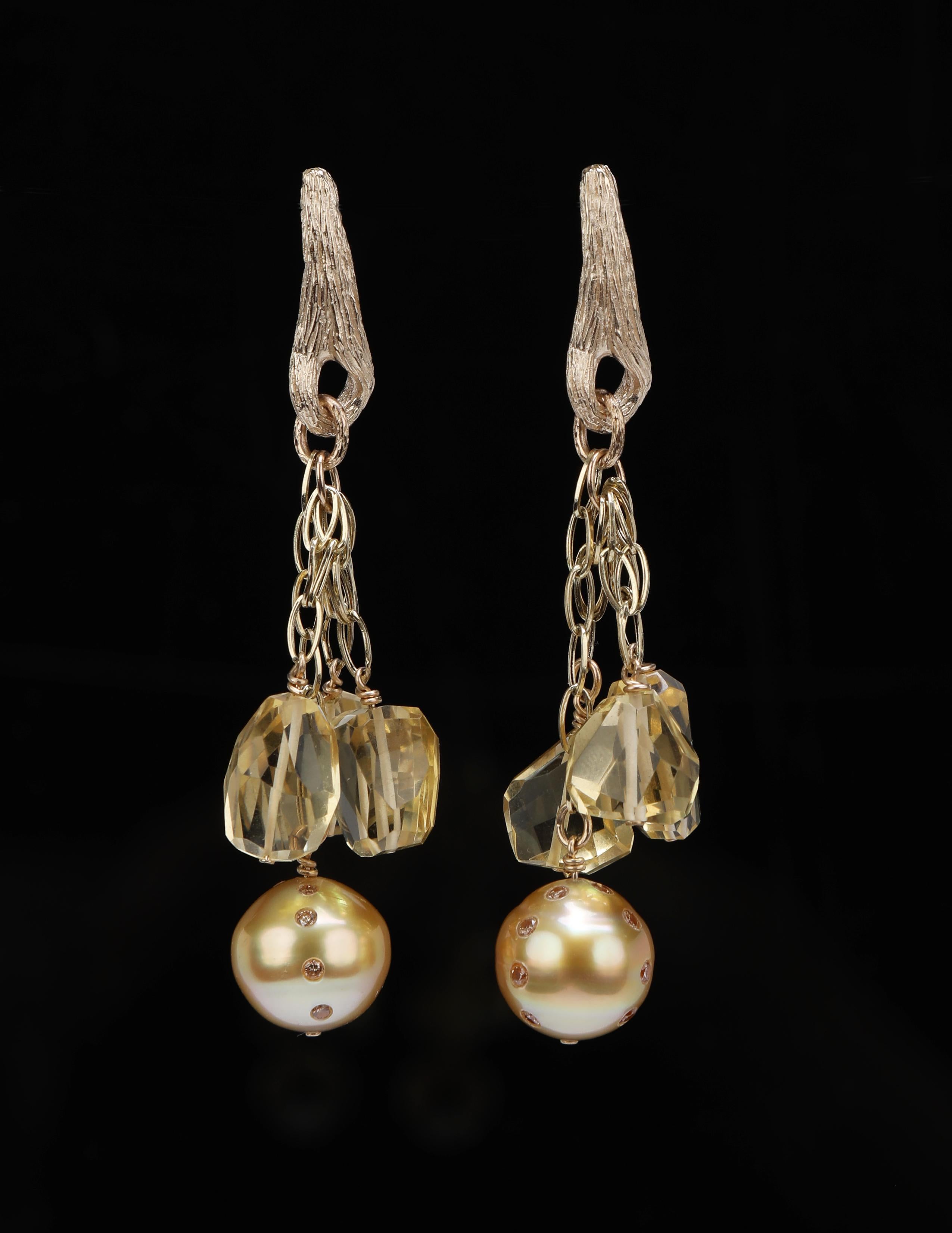 Four gold chains swing under gold vanilla beans.  One chain swings a golden south sea pearl (12mm), embellished by 12, round Champagne diamonds (approximately .64 cts. in weight).  The remaining 3 chains swing faceted, organic shapes of citrine. 