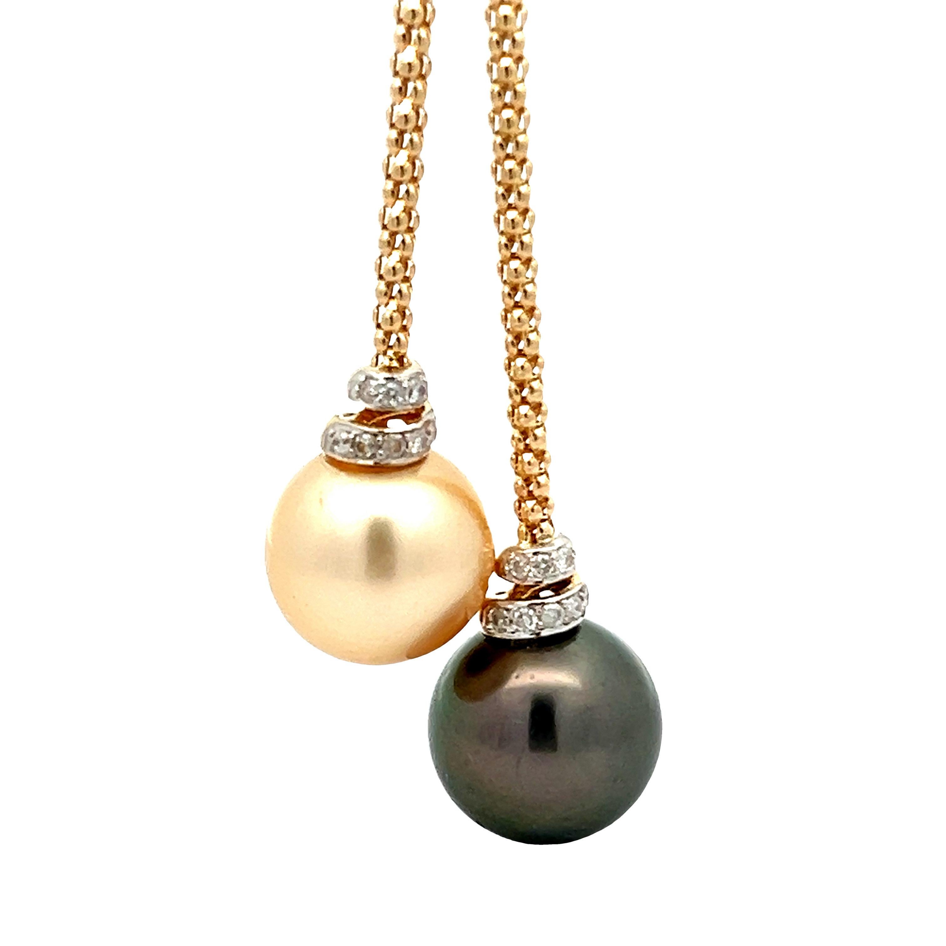 Elegant tahitian and golden south sea pearl necklac. High luster 14.5mm Tahitain pearl & 14mm golden south sea pearls dangling on a necklace, accented with round brilliant cut diamonds. Handcrafted design  
set in 14 karats yellow gold with lobster