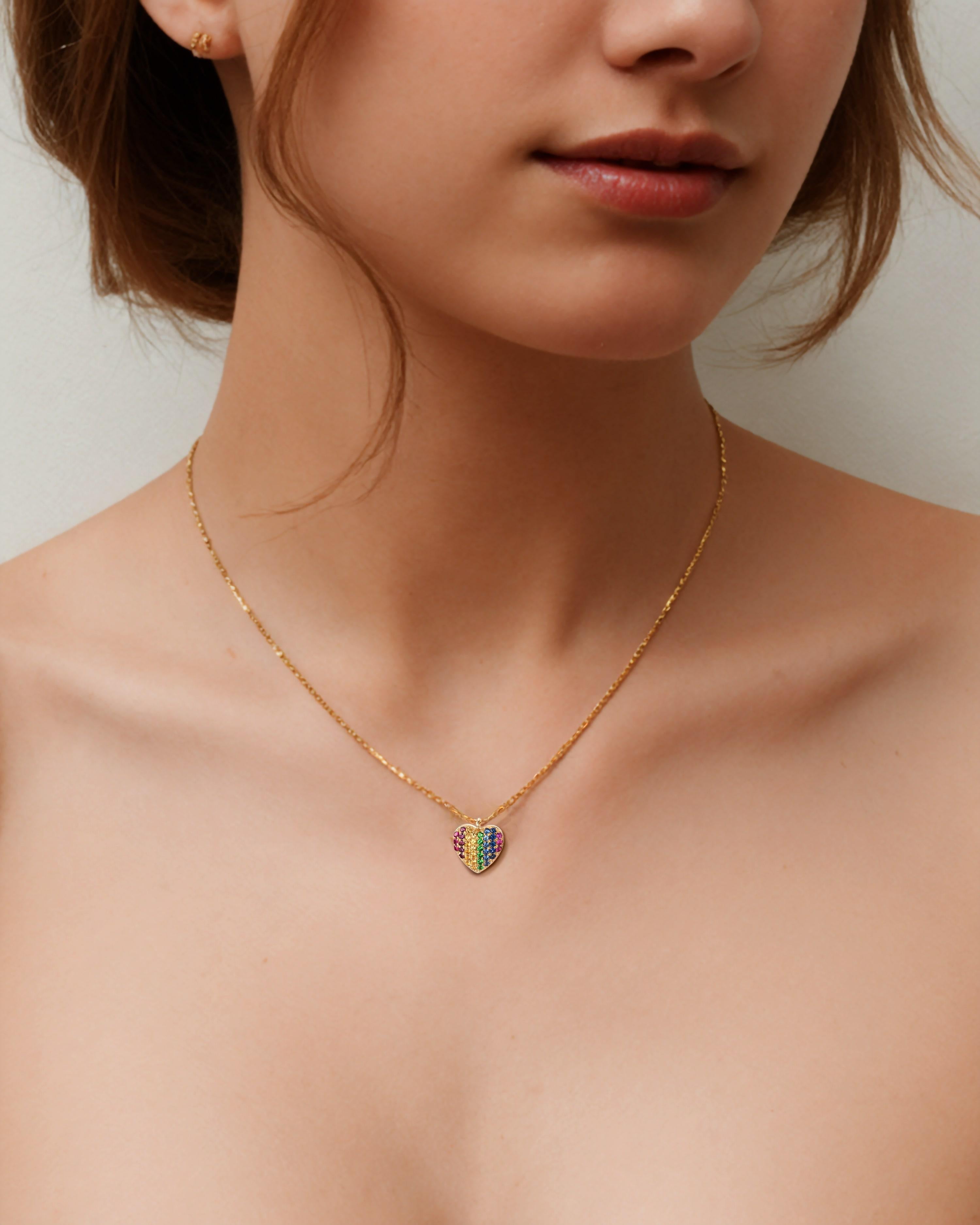 Elegant and timeless, this Heart Pave Round Multicolor Sapphire 14K Yellow Gold Necklace features a dazzling array of multi-colored gemstones, set meticulously to catch the light and add a vibrant touch to any outfit. Each stone is hand-selected for