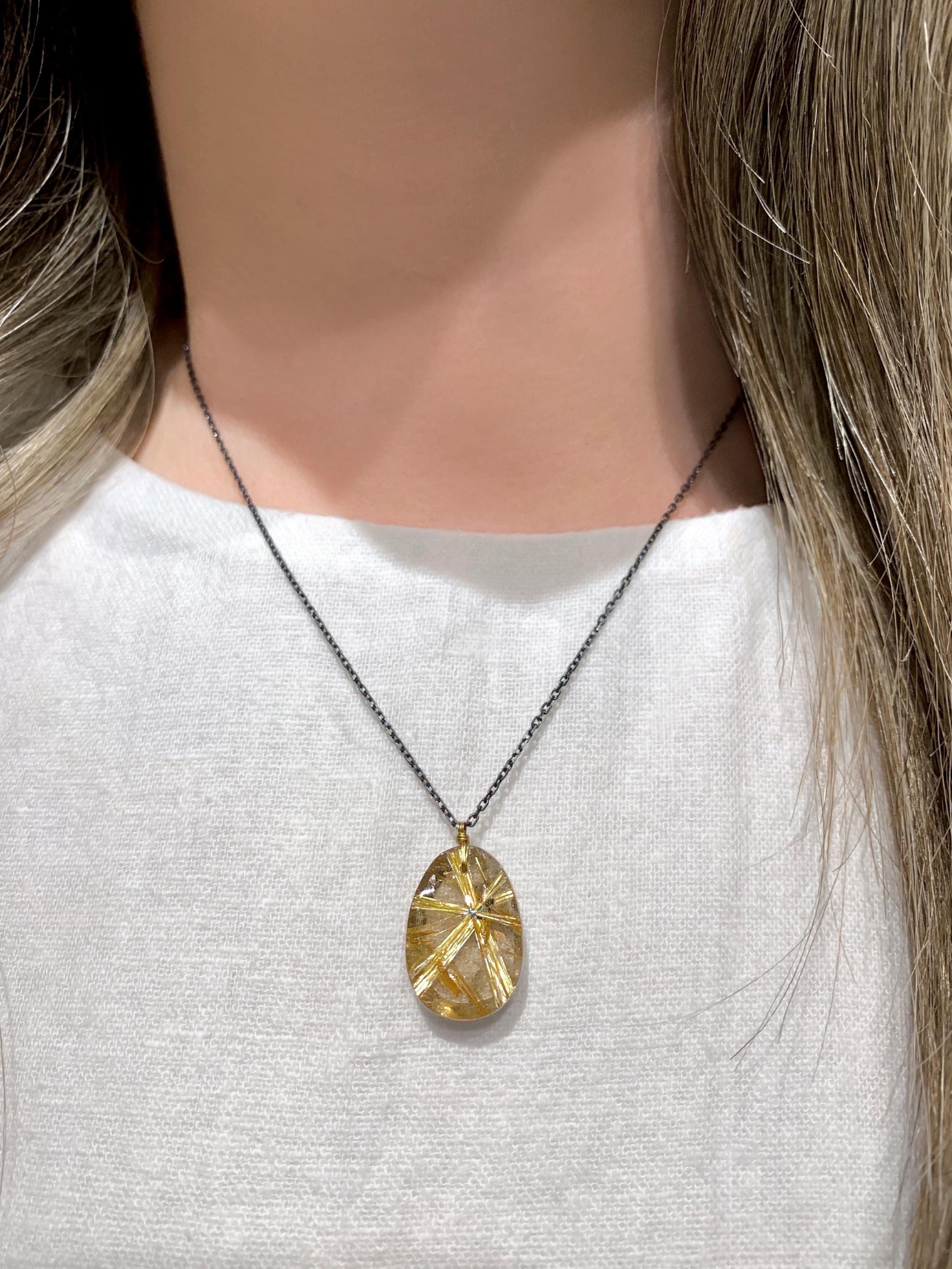 One of a Kind Necklace handmade by renowned jewelry designer Dana Kellin featuring a brilliant rutilated quartz pendant showcasing a prominent golden, six-sided rutile star, attached by way of the designer's signature hand-wrapped satin-finished 14k